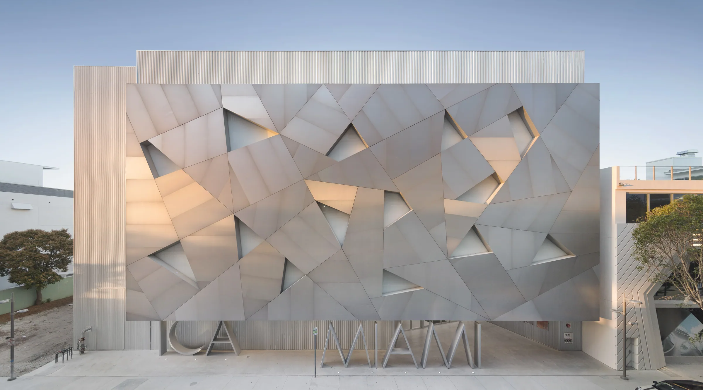 A folded aluminum façade at dusk