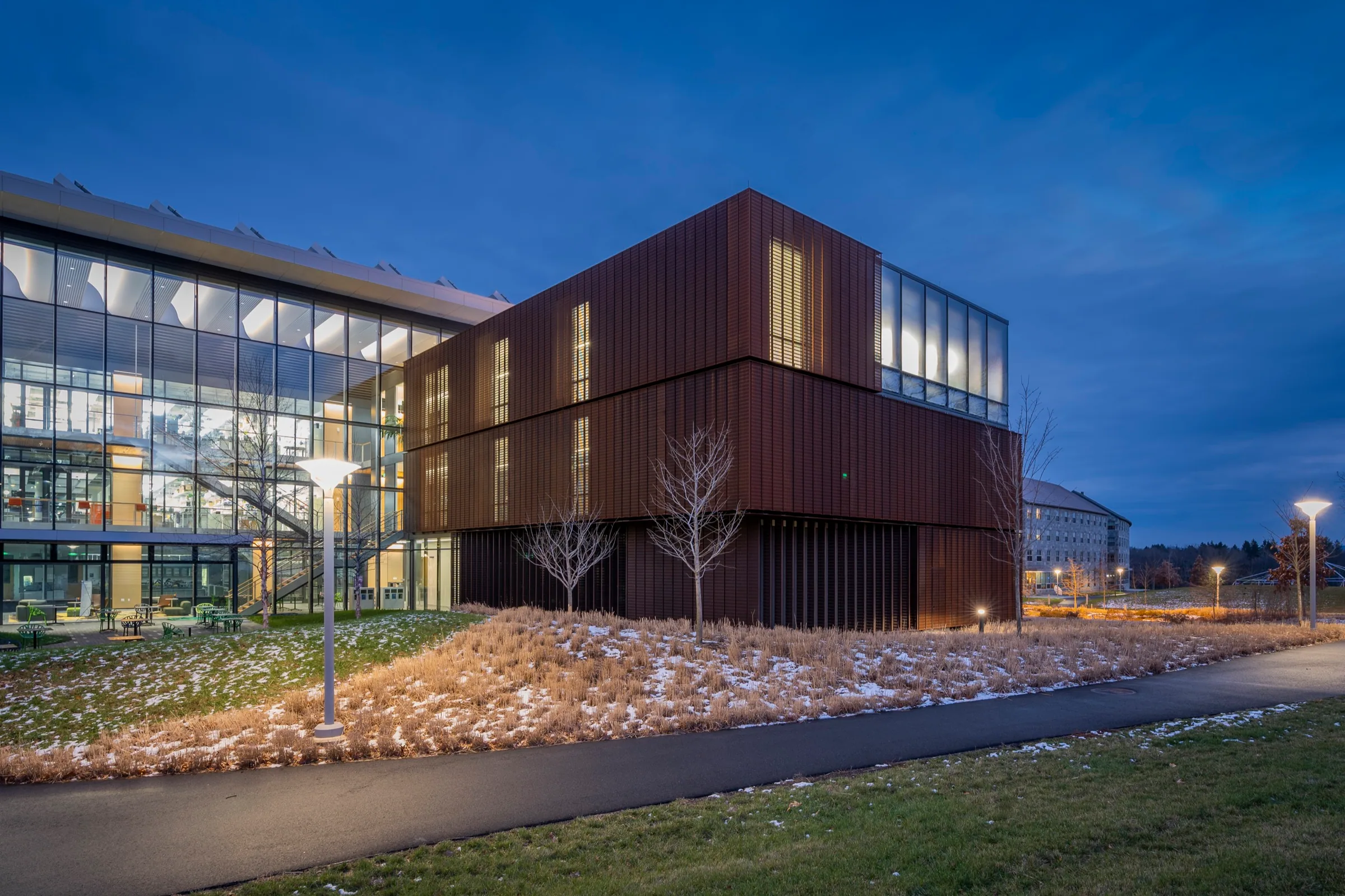 A copper-clad academic building at blue hour