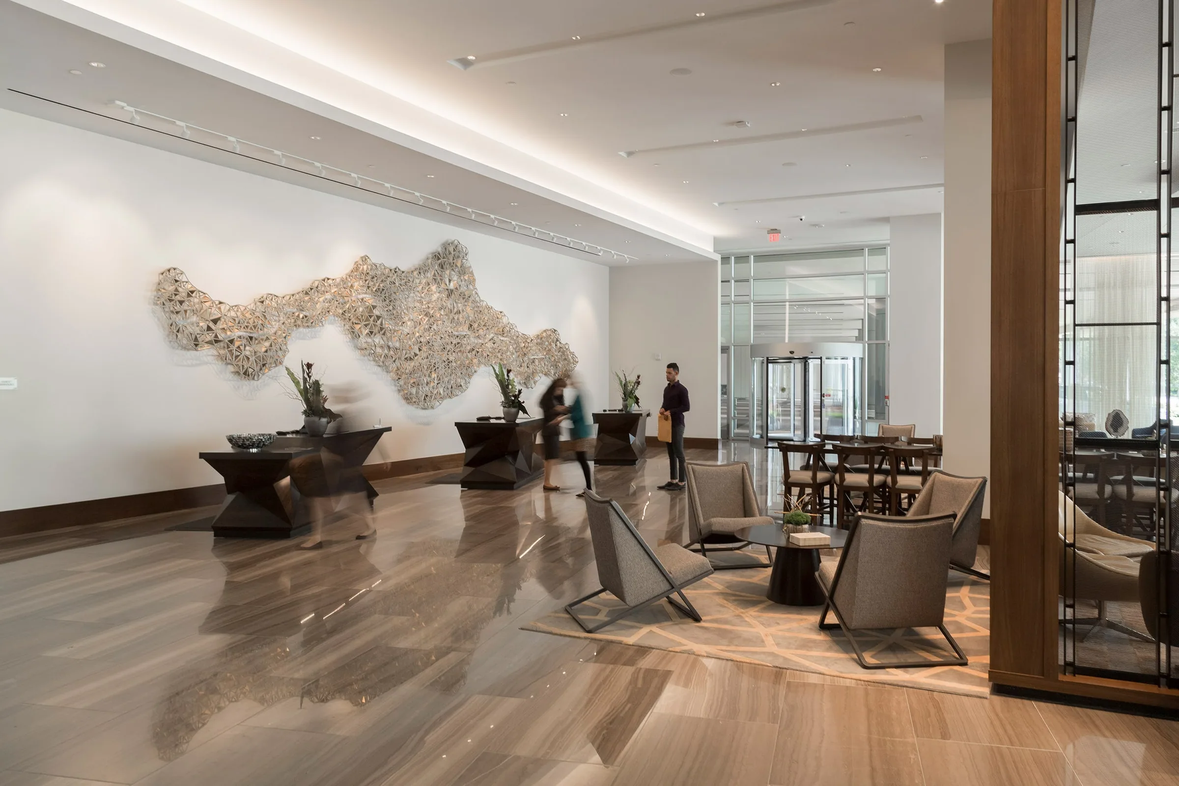 A sculpted metal screen wall in a hotel lobby