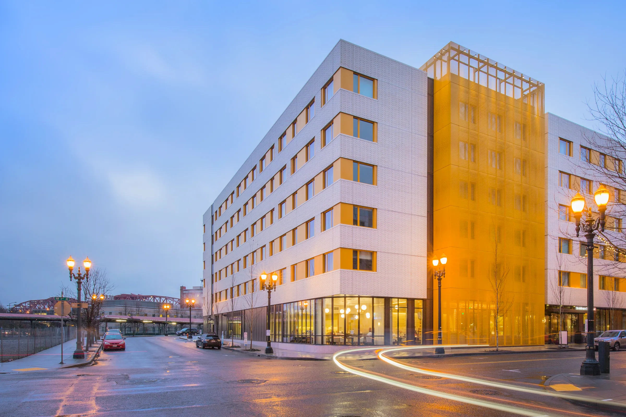 A hotel with a bright yellow perforated panel façade