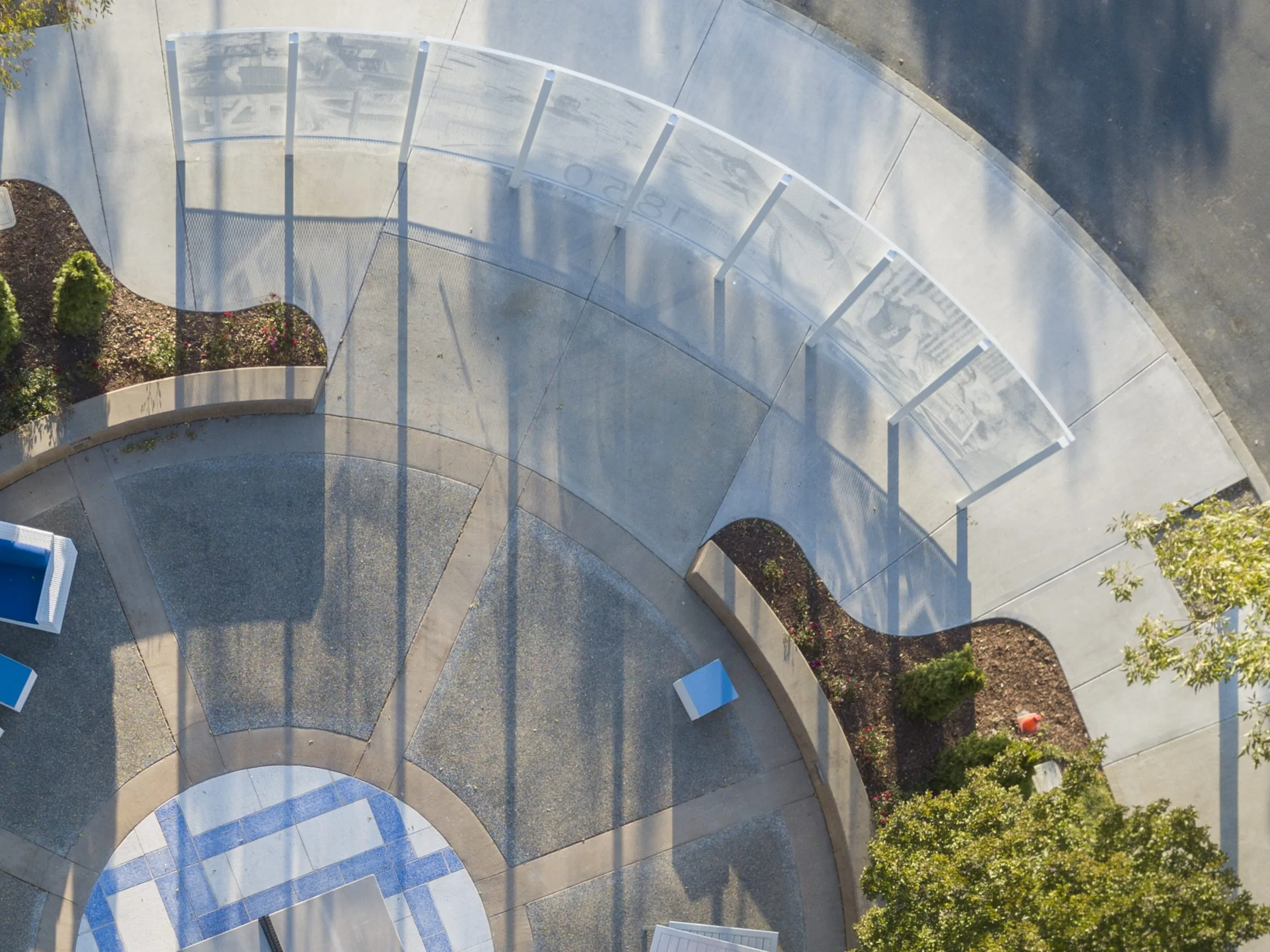 Looking straight down on a curved canopy and plaza