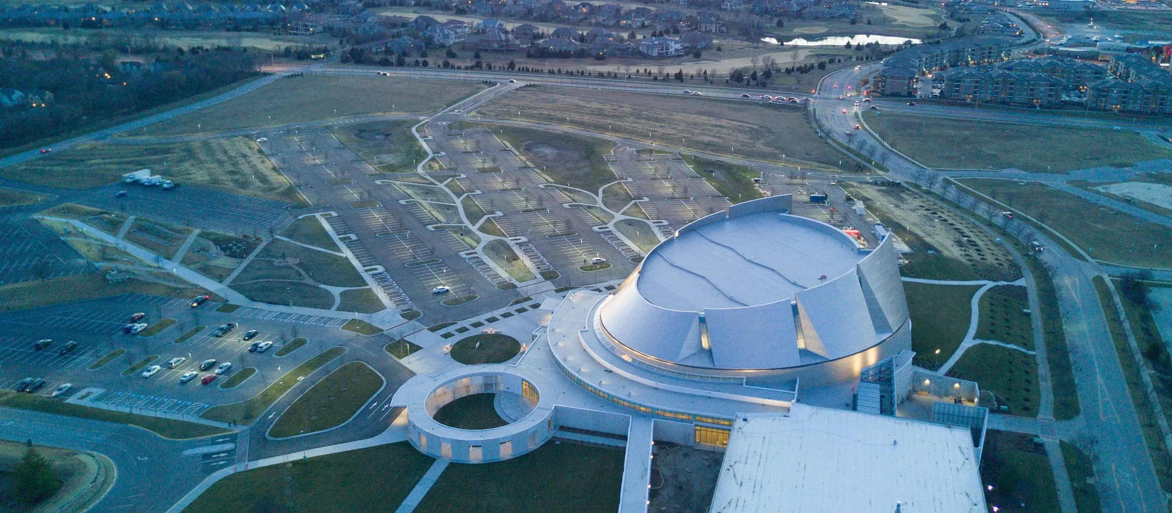 An aerial view of a church campus at dusk