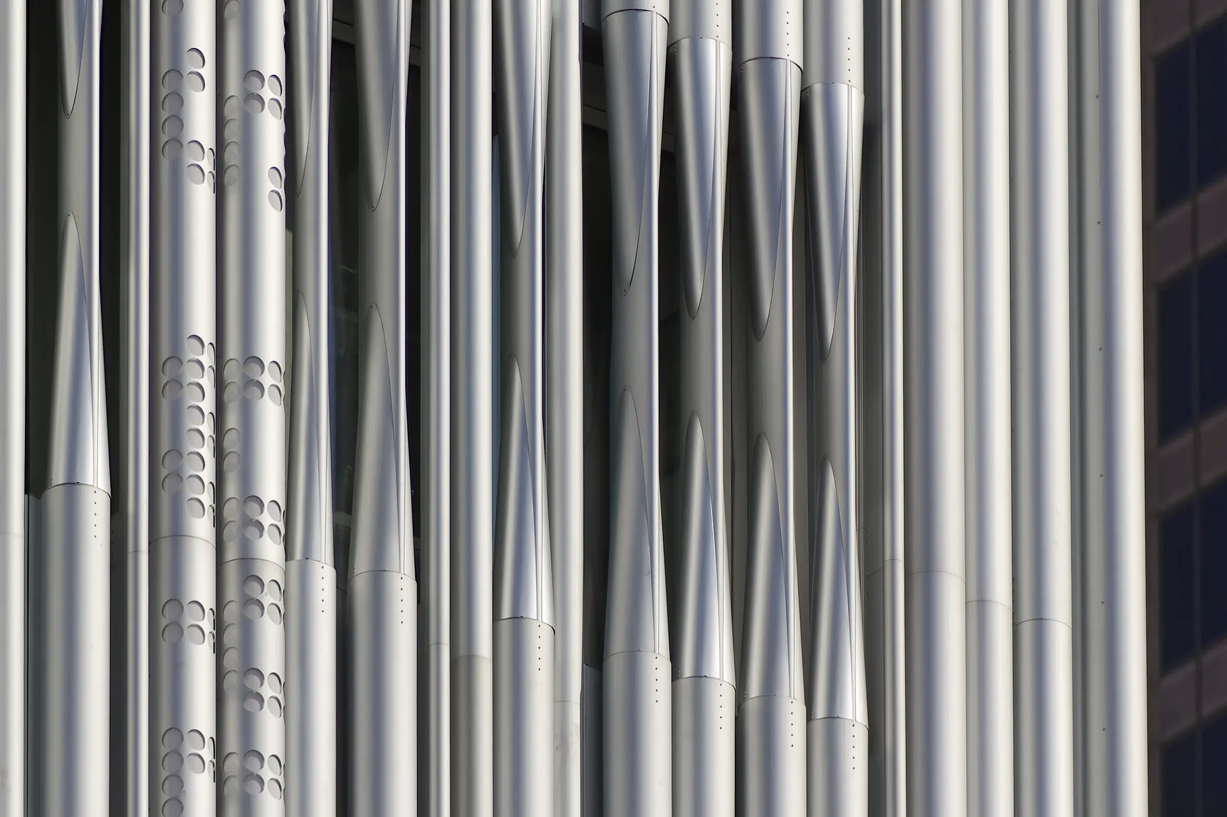 A wall of vertical aluminum tubes