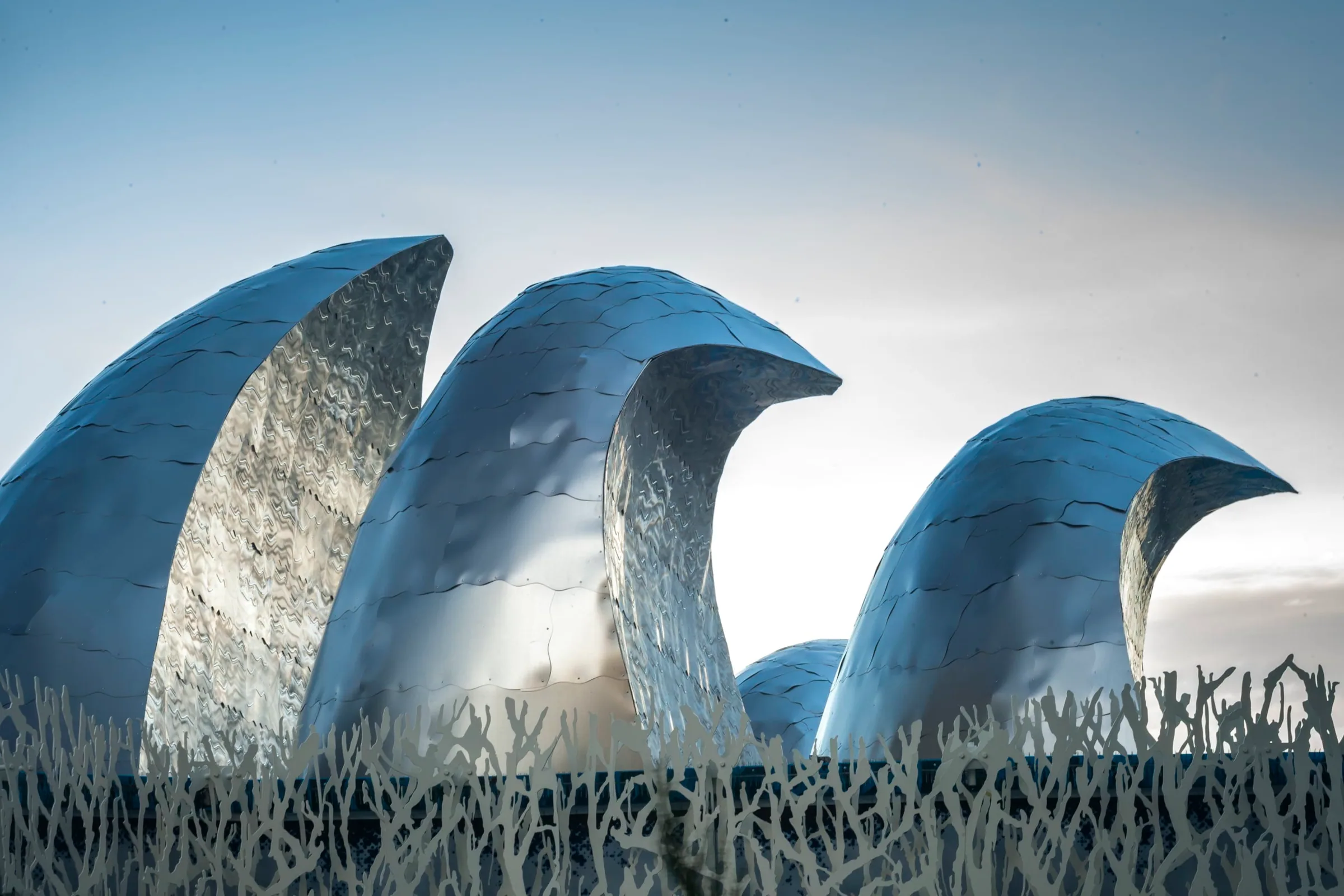 Three steel waves curling up from the façade