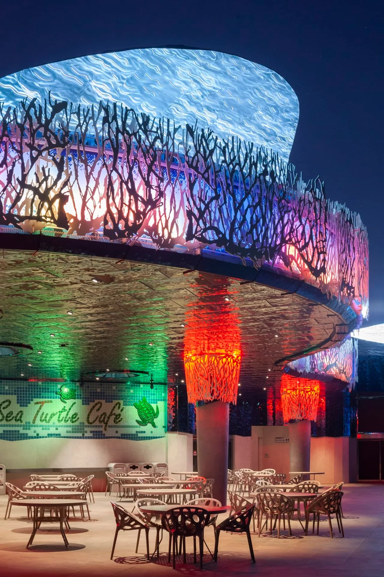A red column under the lit wave canopy