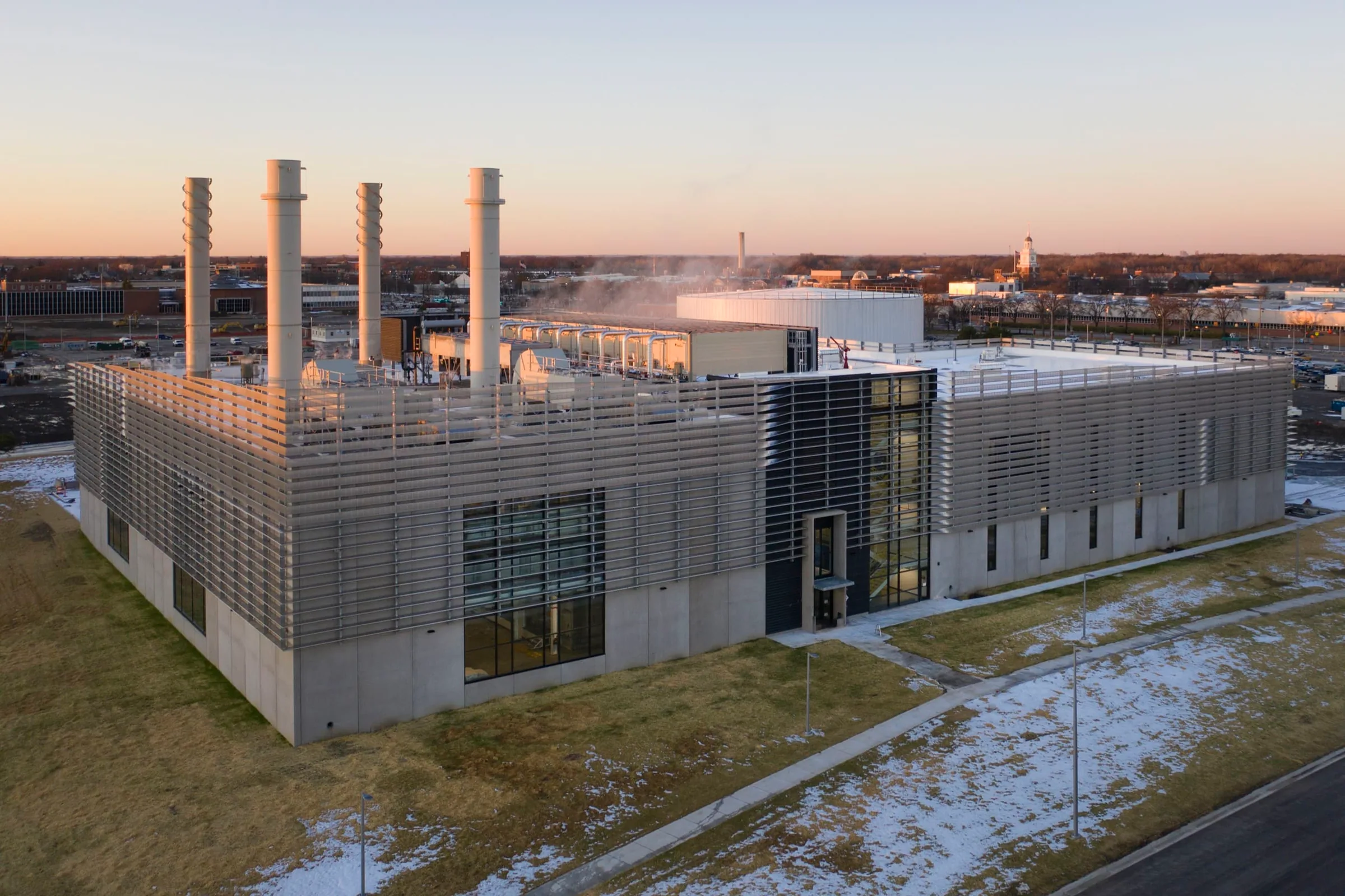 From the air: the plant and its stacks at sunset, snow on the ground