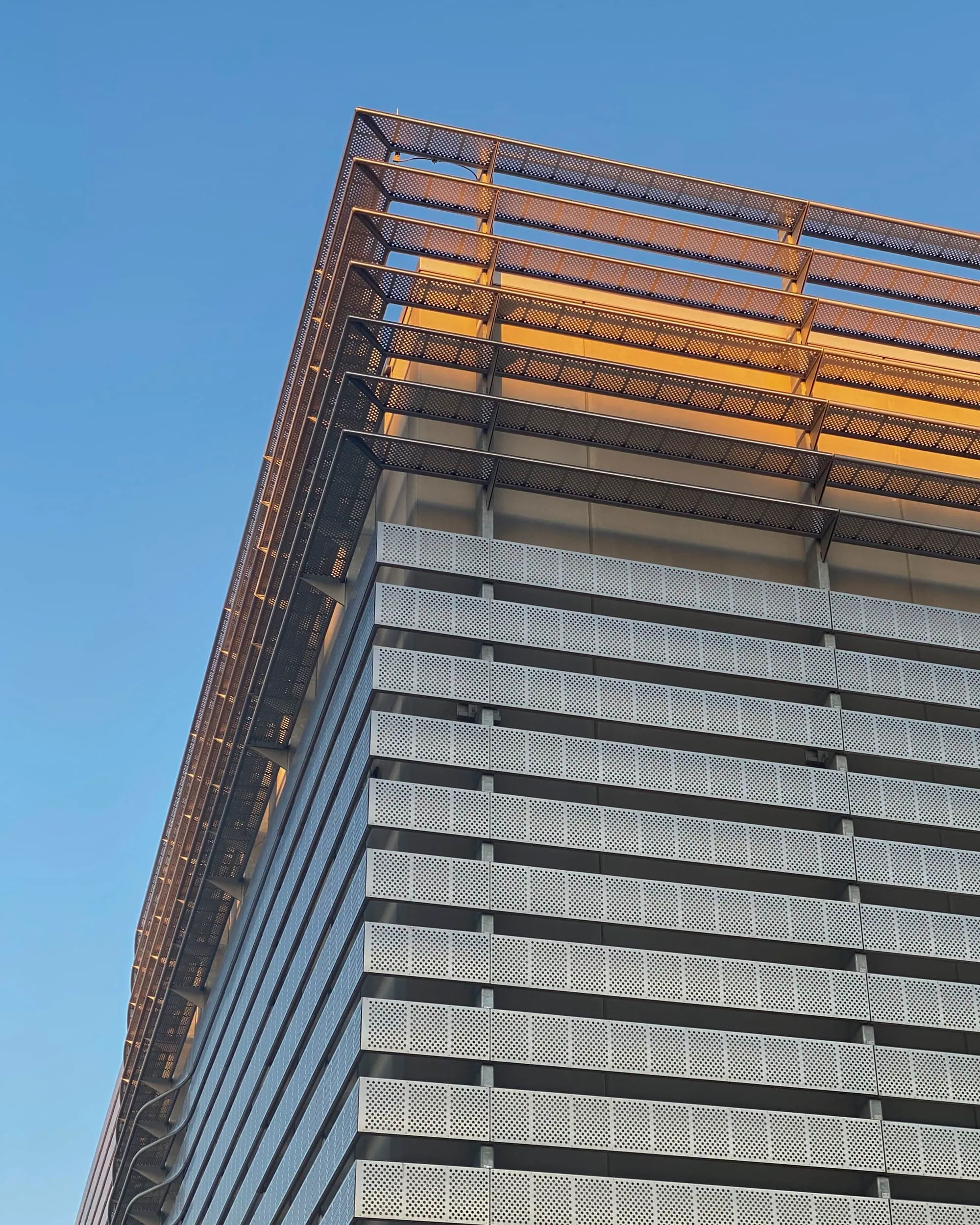 The top edge of the finned façade catching the sun