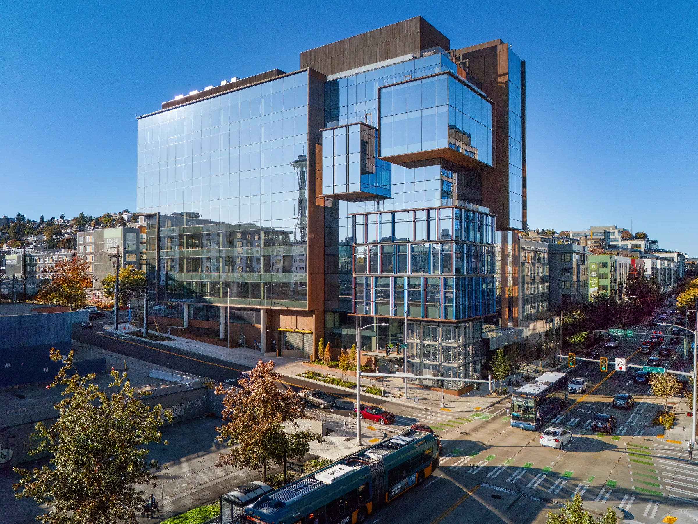 The building’s stacked glass volumes above the neighborhood
