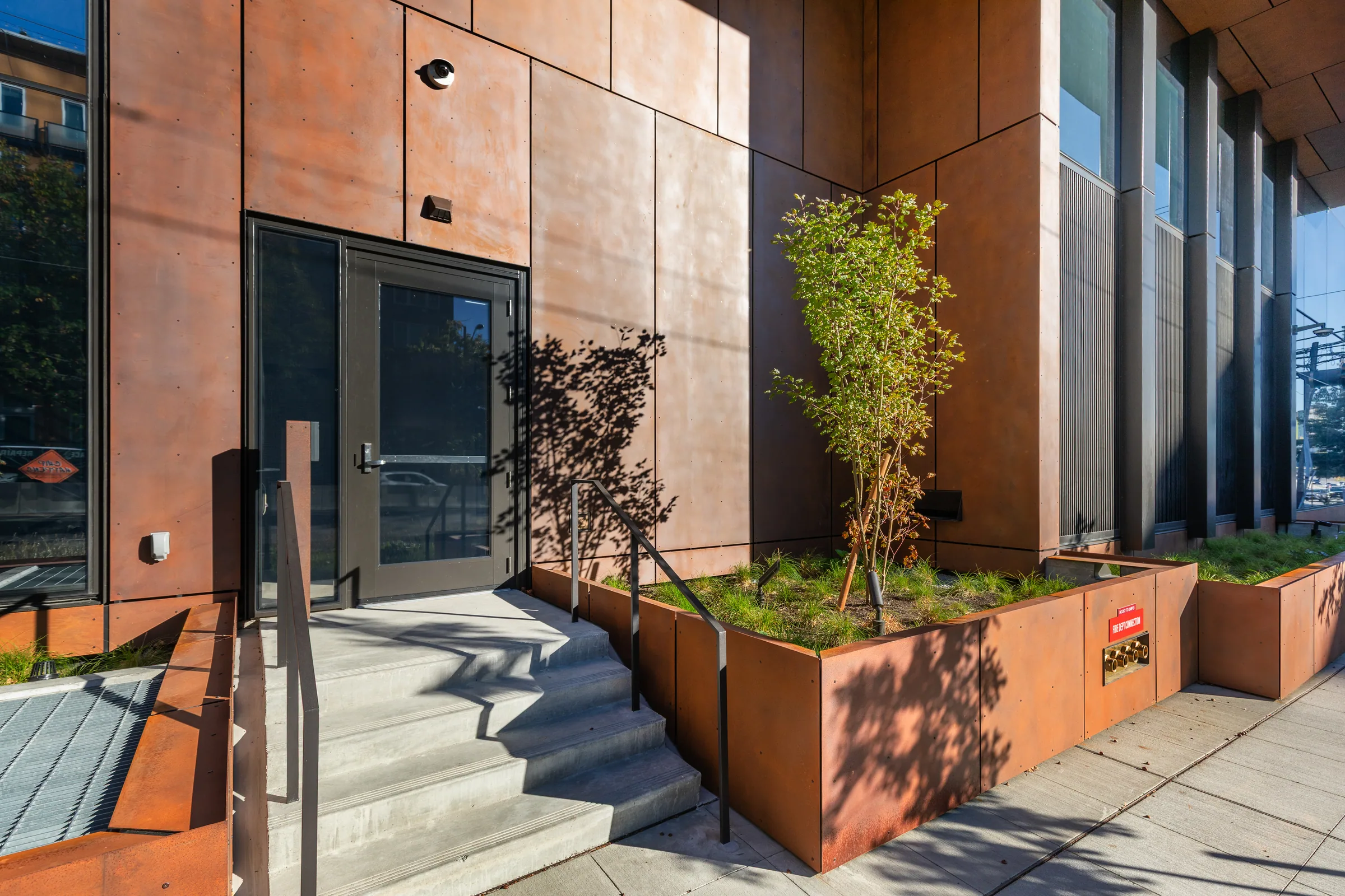 Stairs and planters in weathering steel at the entrance