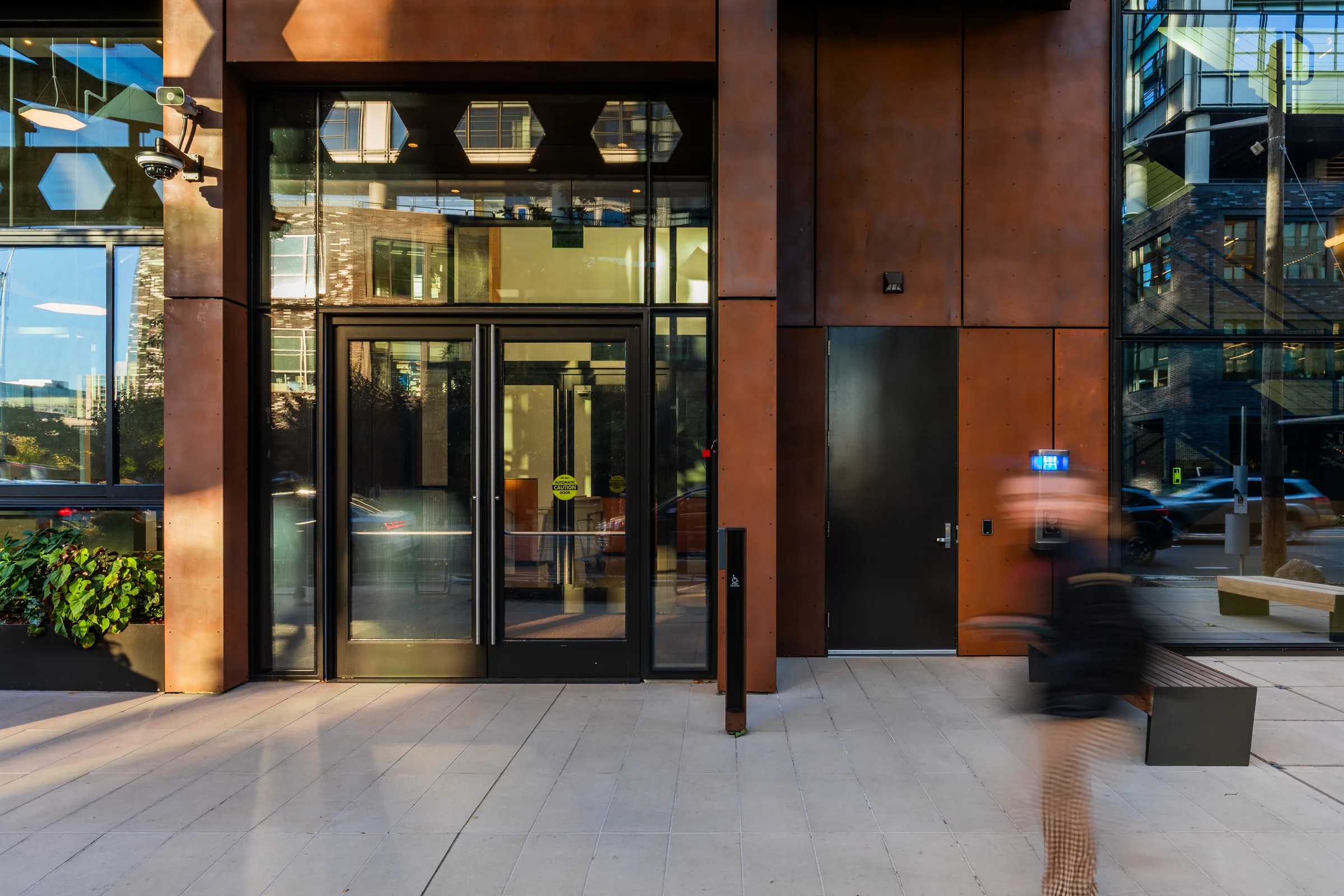 The glass entry framed in steel panels