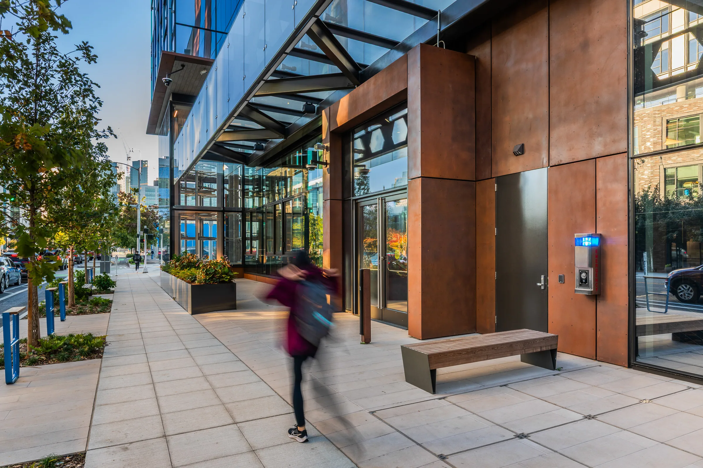 A pedestrian passing the steel-clad lobby