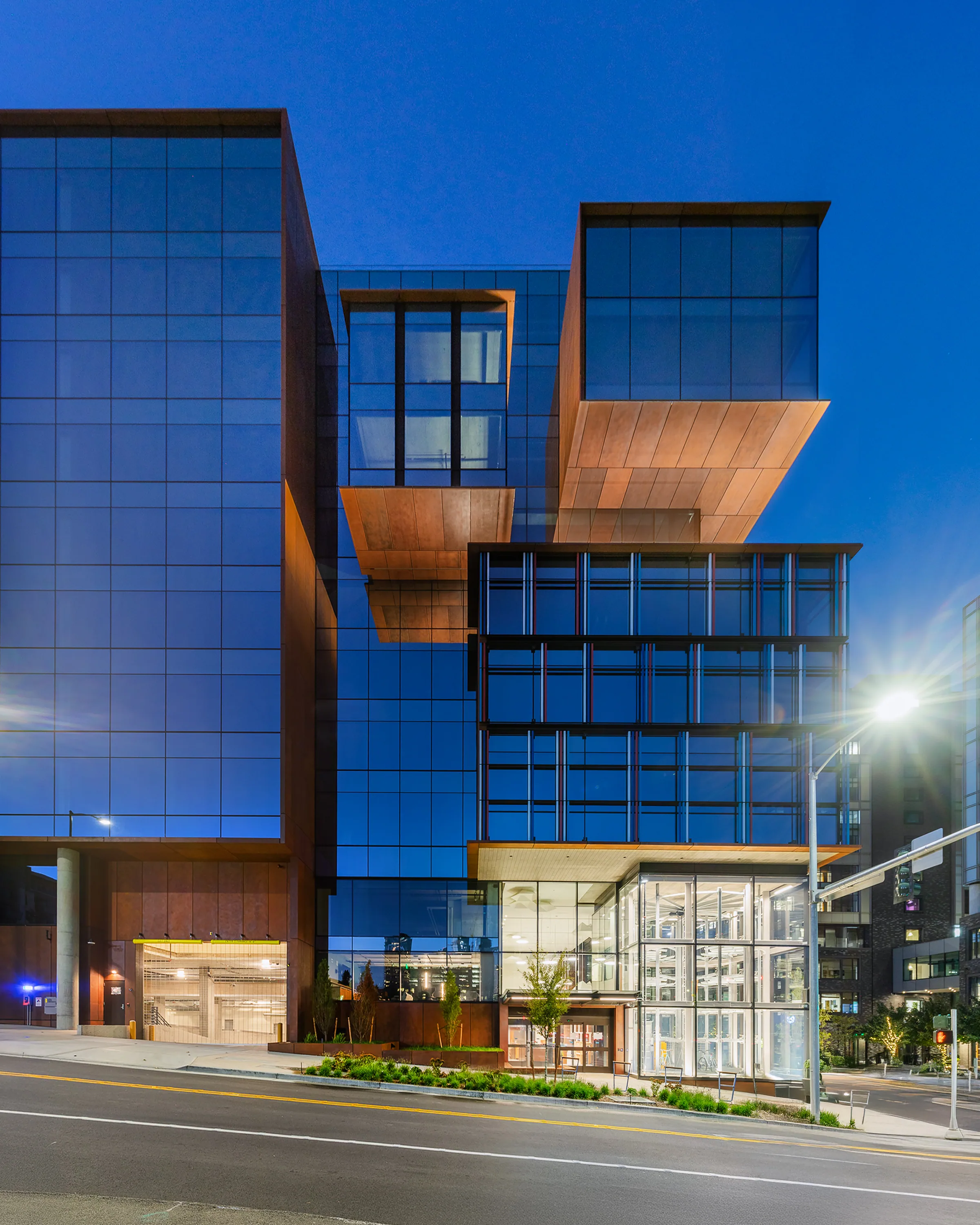 The corner at night, steel panels lit from below