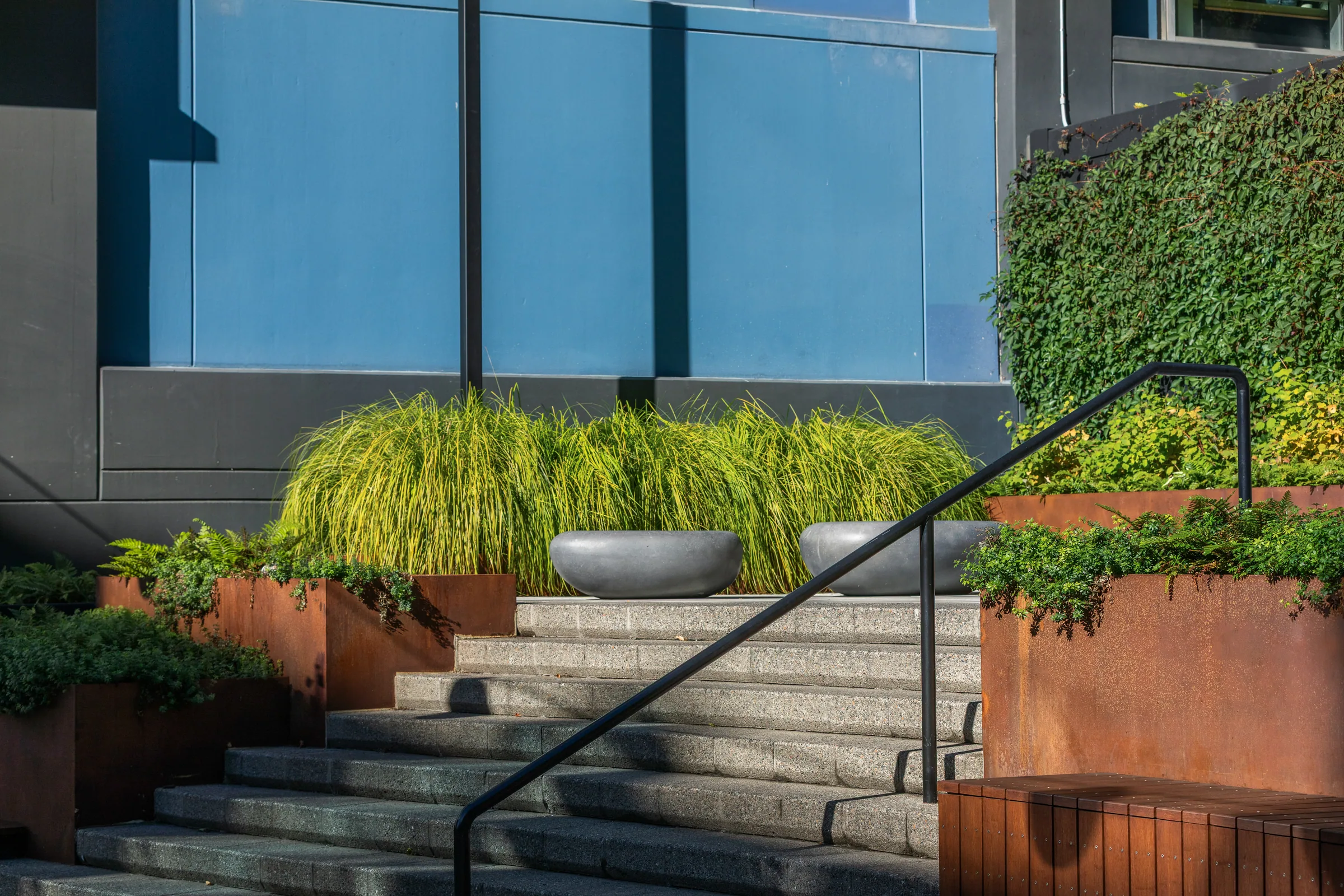 Steel planters stepping up beside a railing