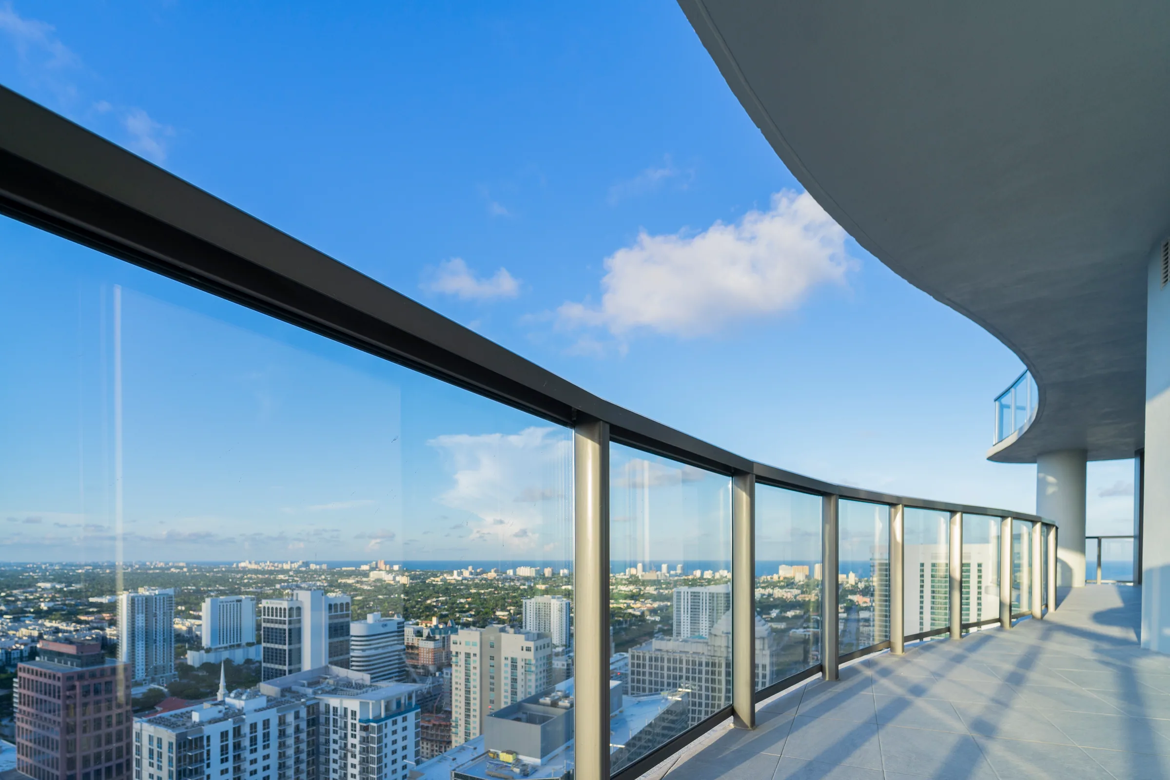 A glass railing sweeping around a curved balcony