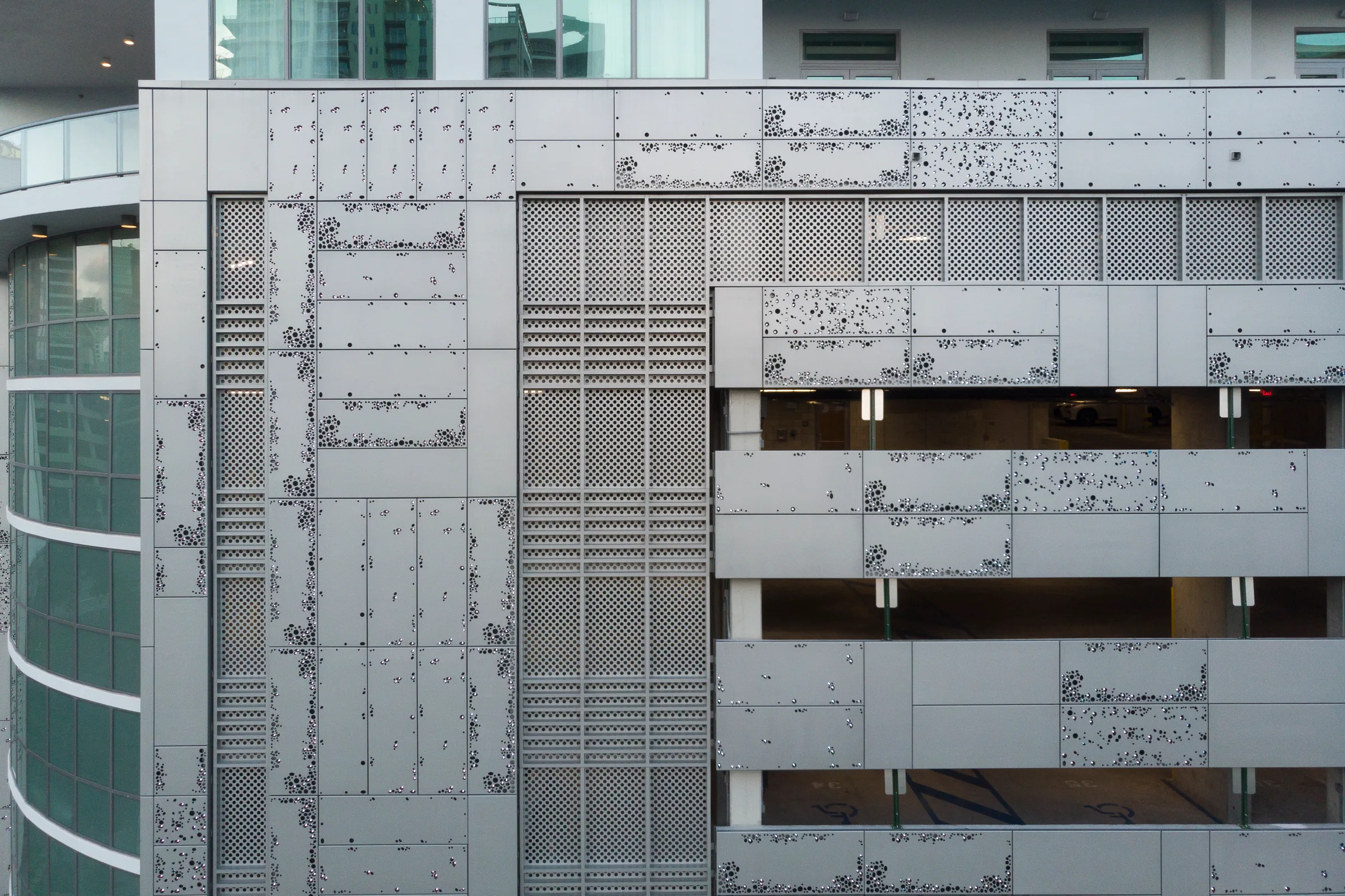 Perforated garage panels in a scattered dot pattern