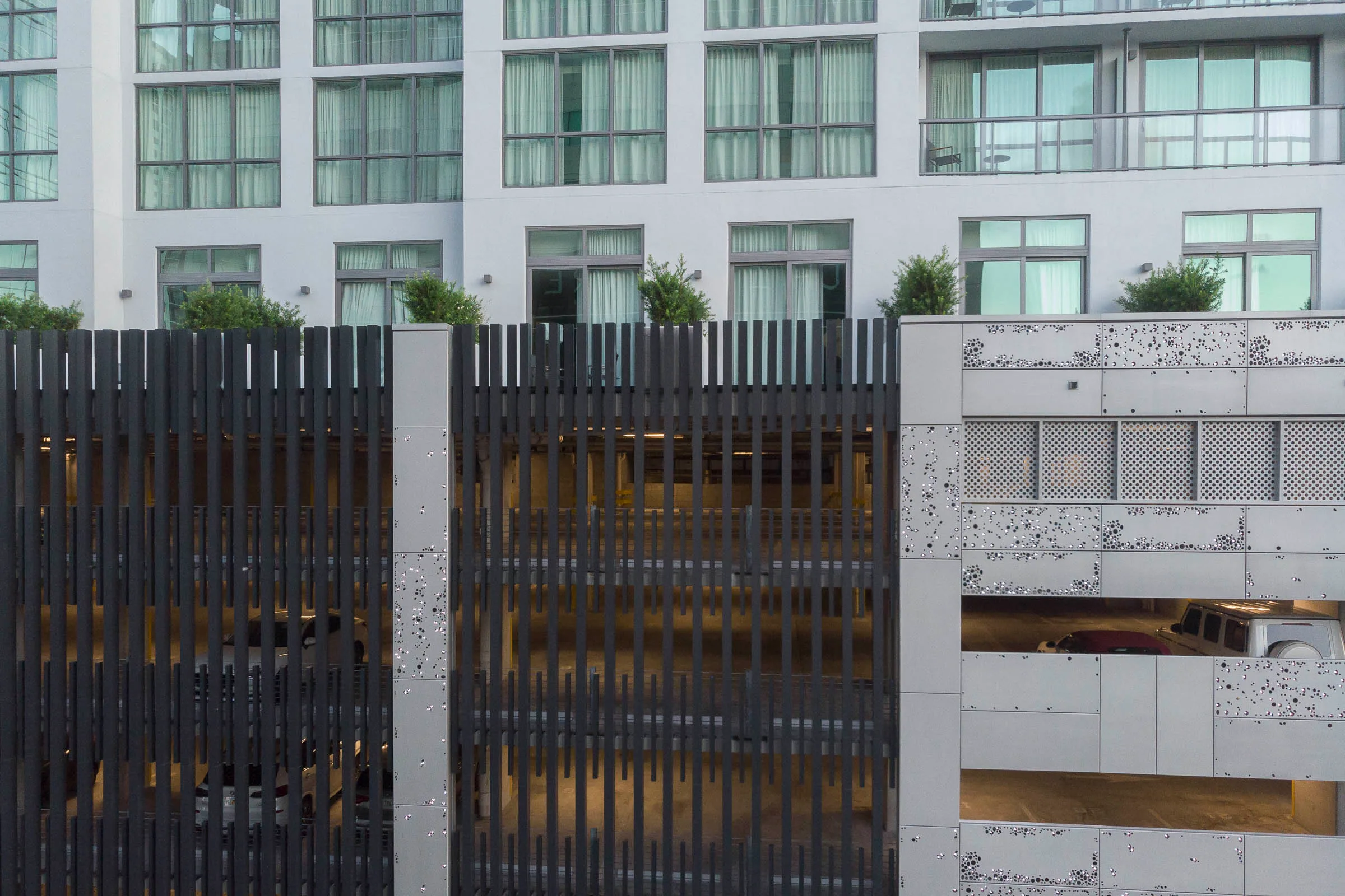 Dark slatted screens set in the garage façade