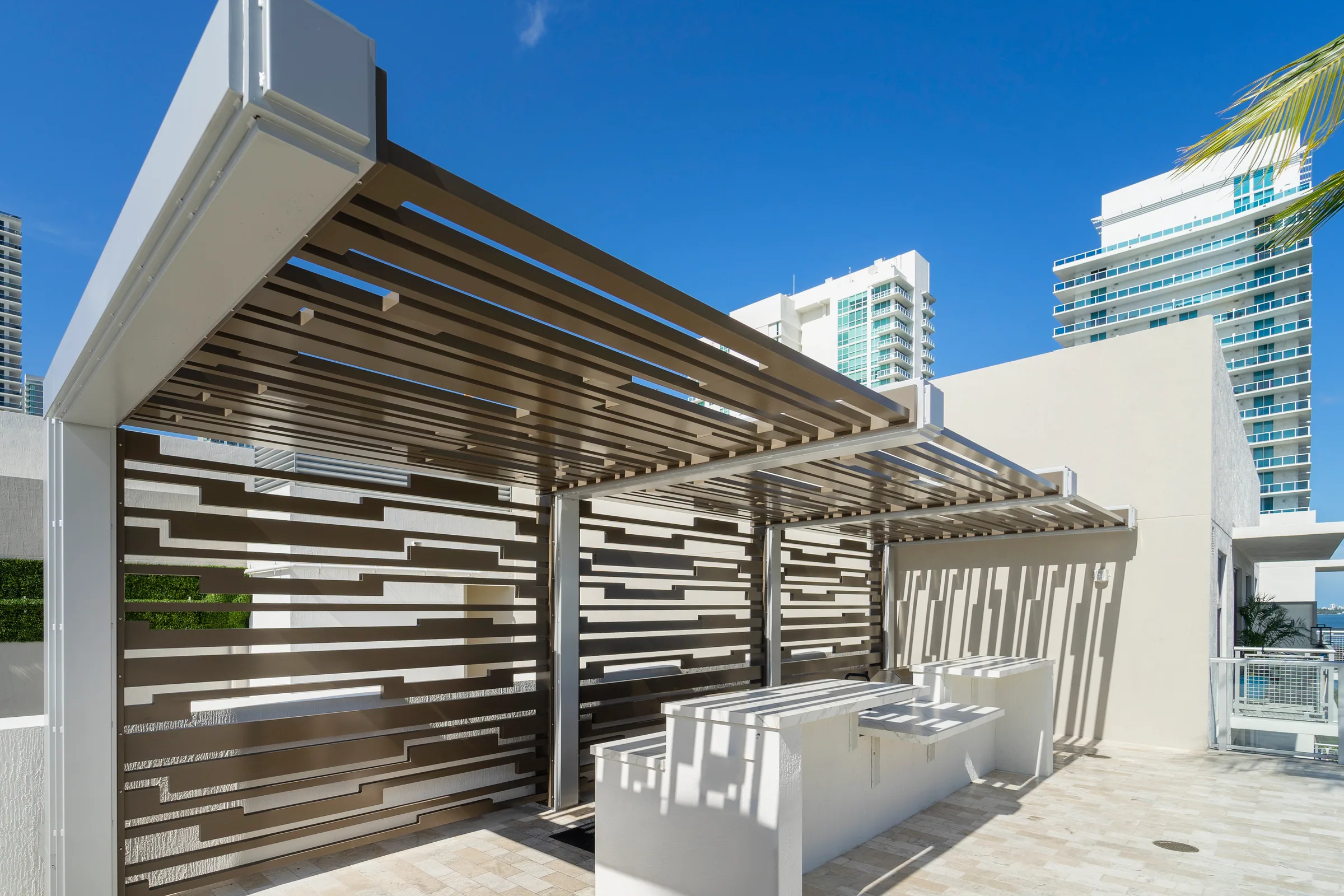 The slatted cabana and canopy beside the pool
