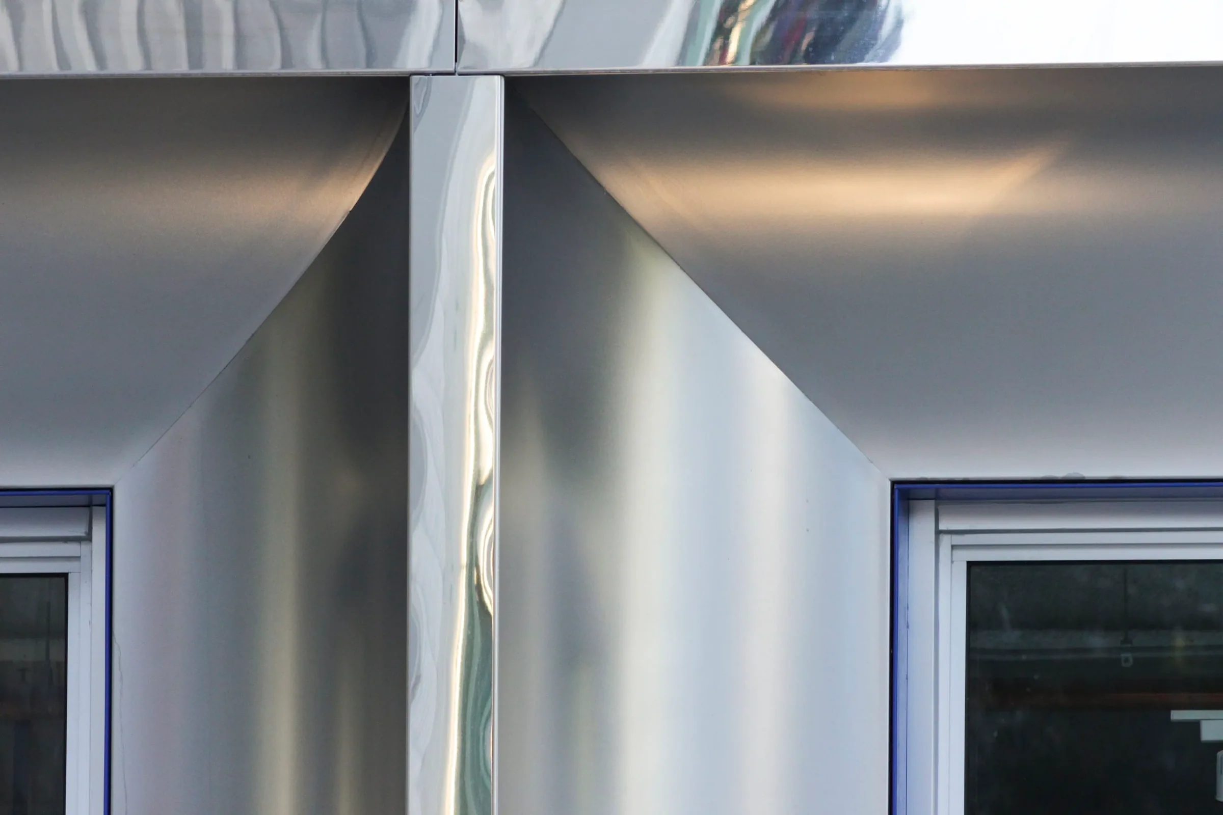 Stainless steel curving down into a column
