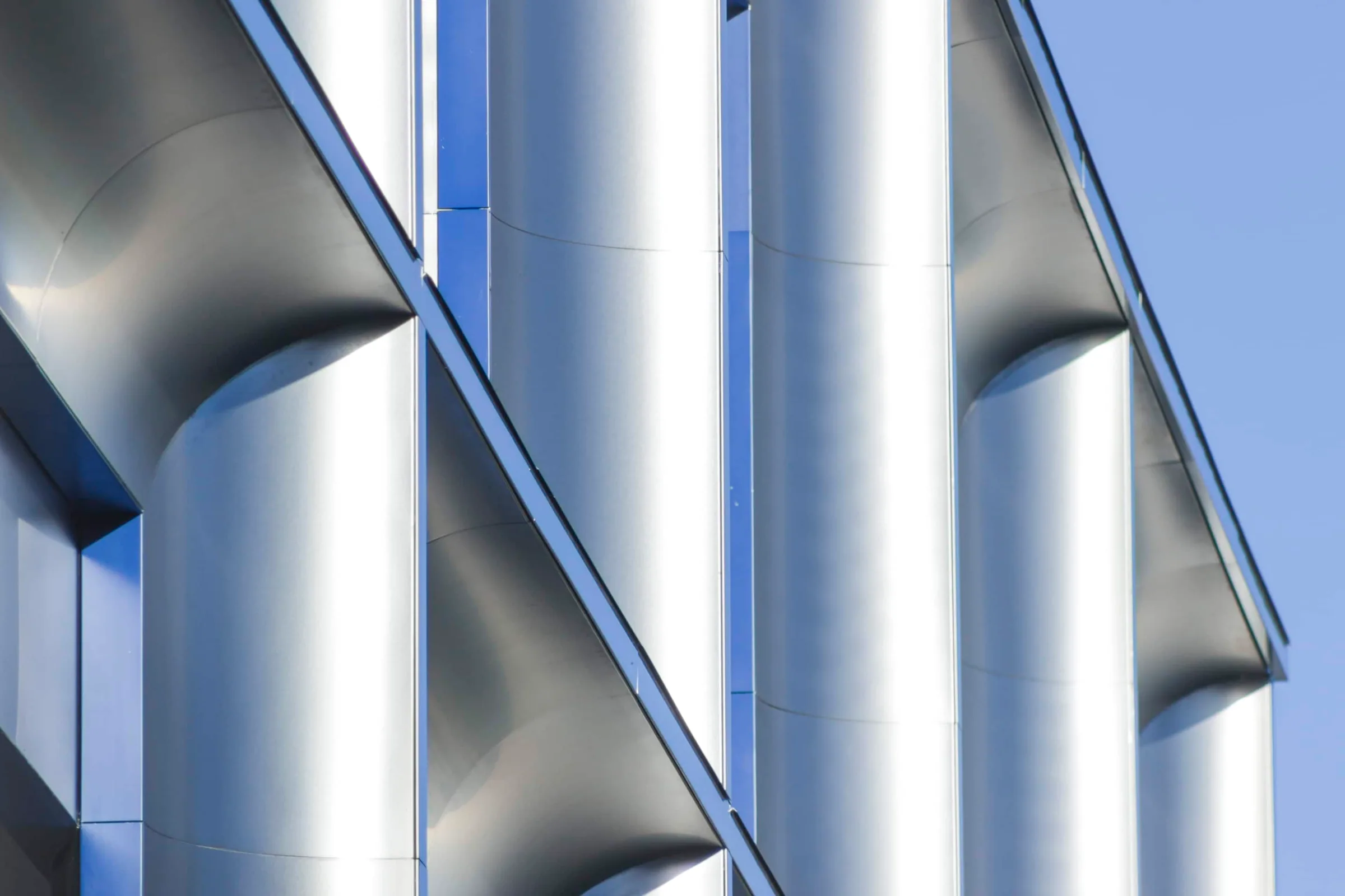 Curved stainless steel columns catching the light
