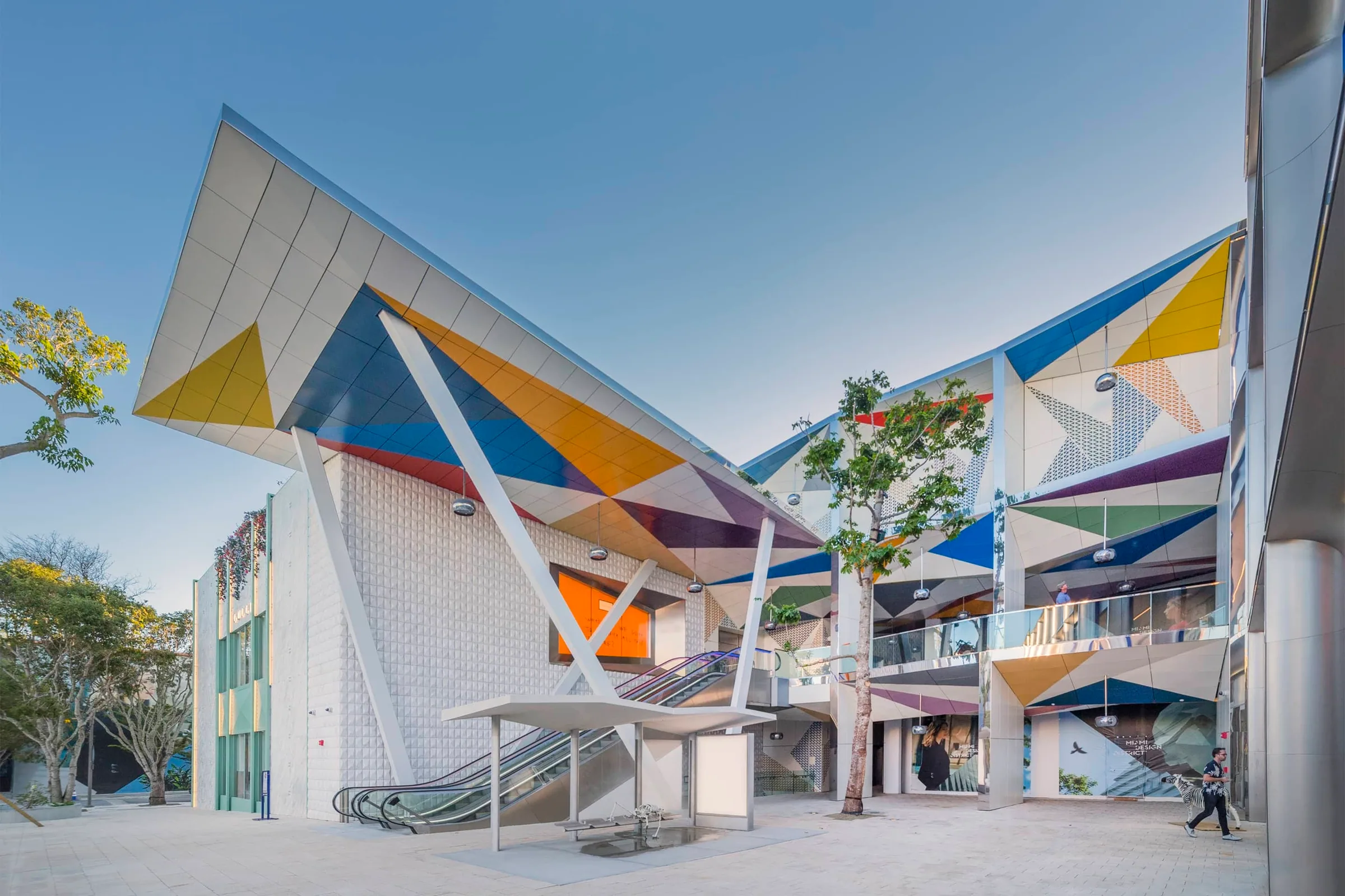 Paradise Plaza’s angled panels in blue, yellow and red over a courtyard
