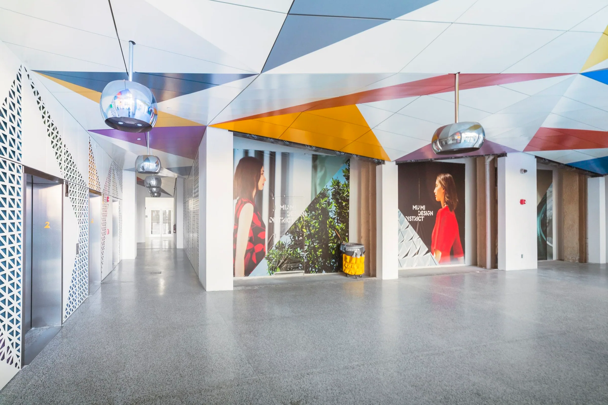 Painted ceiling panels and mirrored pendant lights over a hall