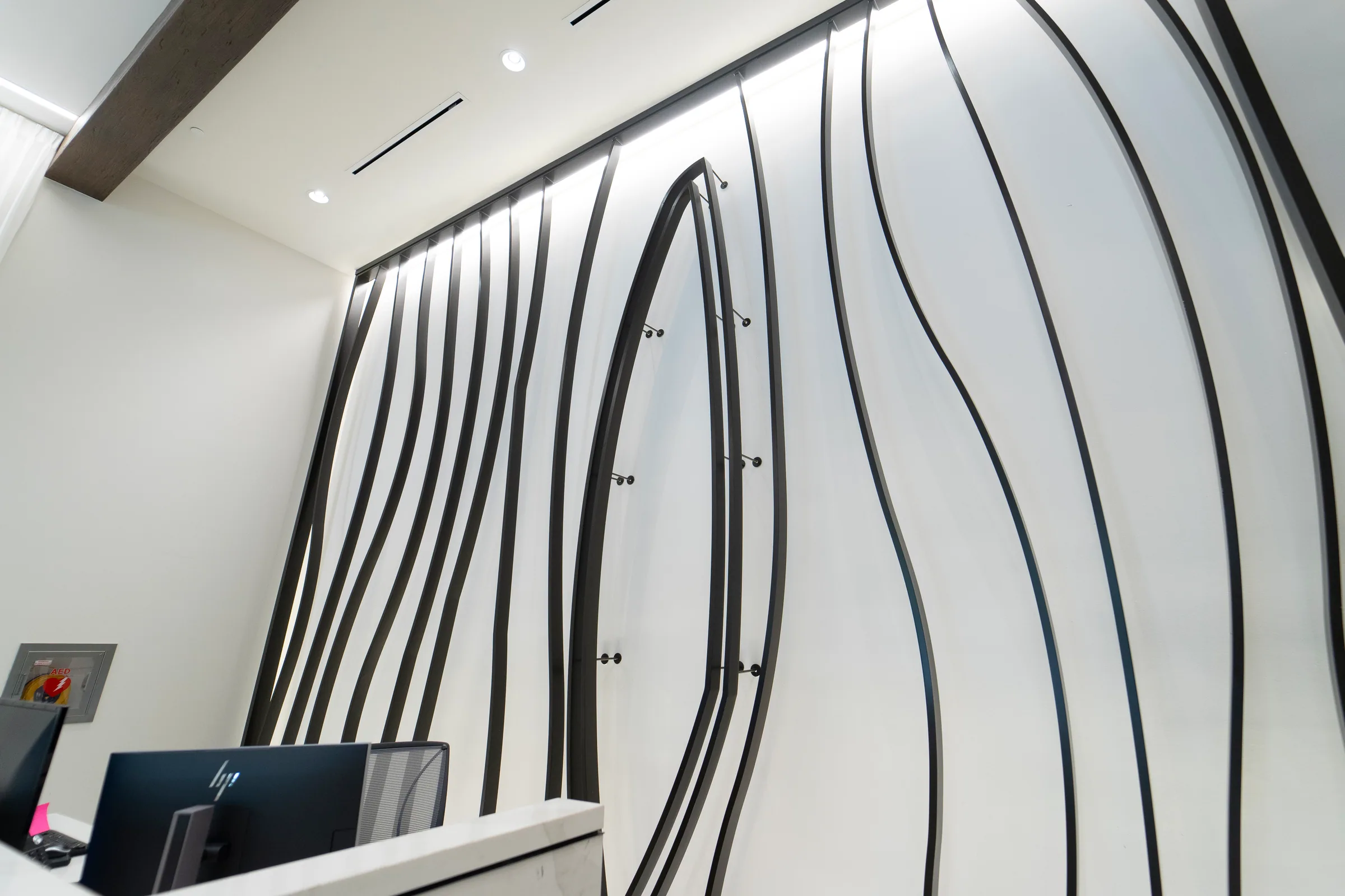 Black steel ribbons on a white lobby wall
