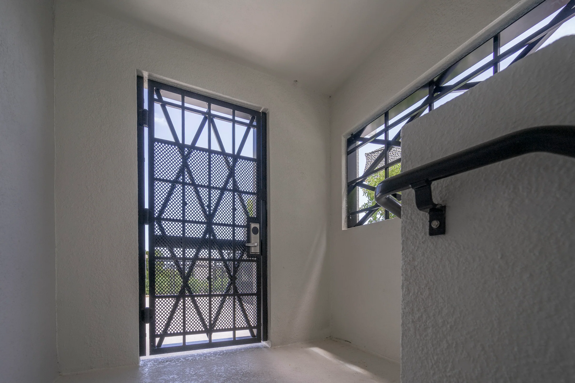 A patterned steel grille in a stair window