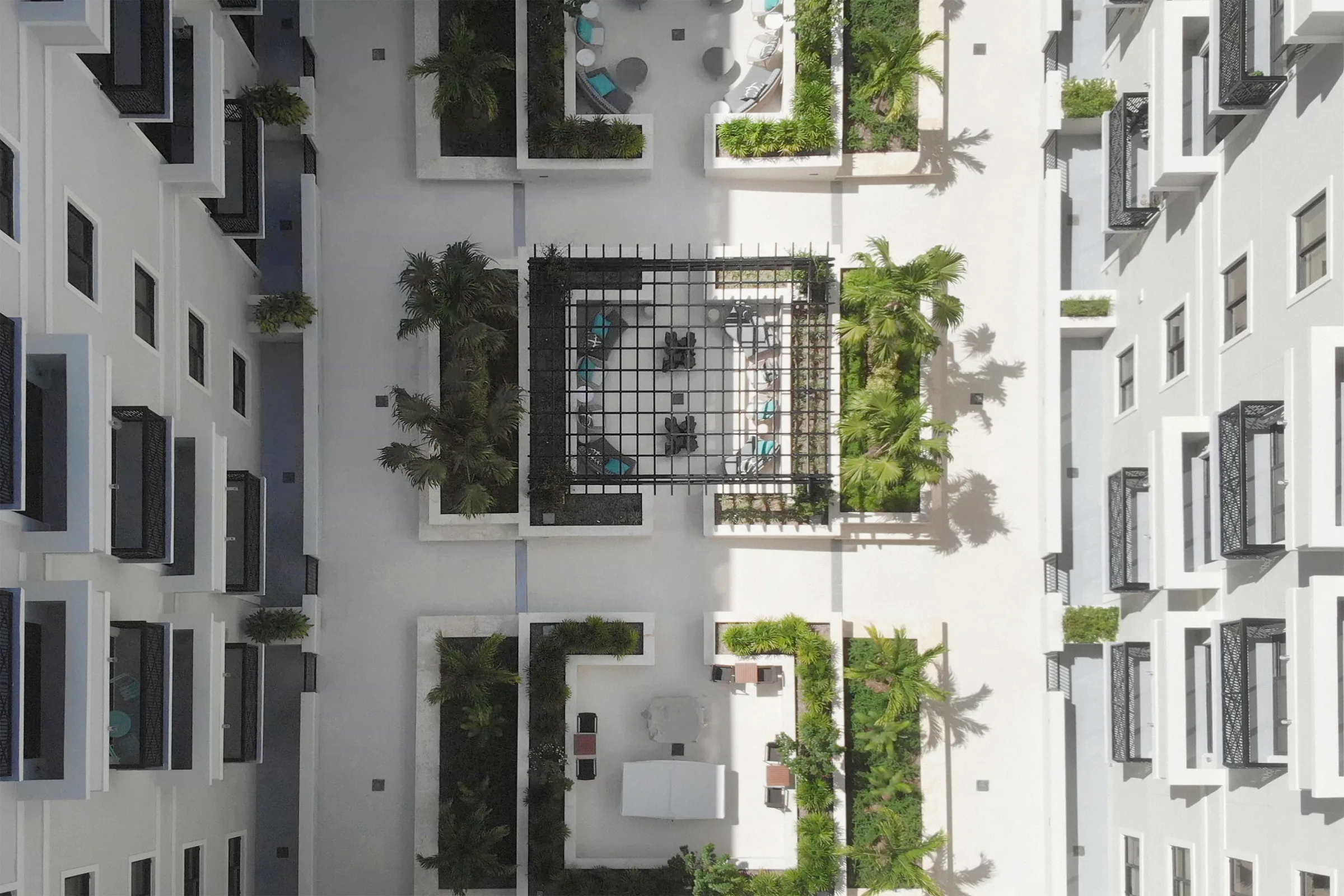 Looking straight down into a planted courtyard with a pergola