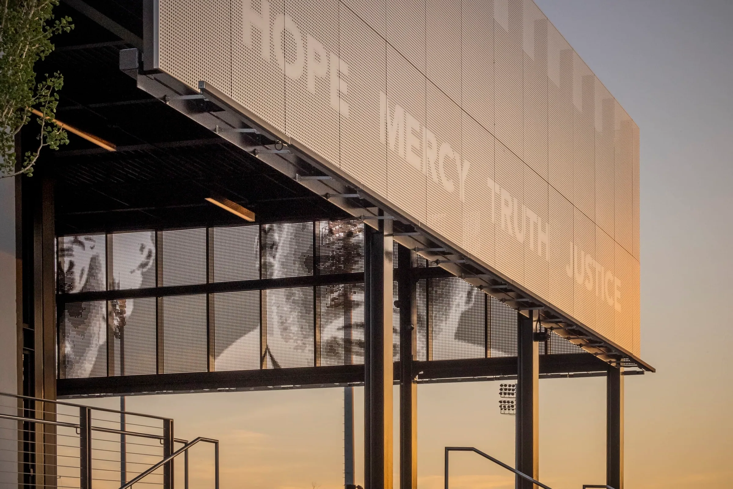 The words Hope, Mercy, Truth, Justice perforated into the awning’s end