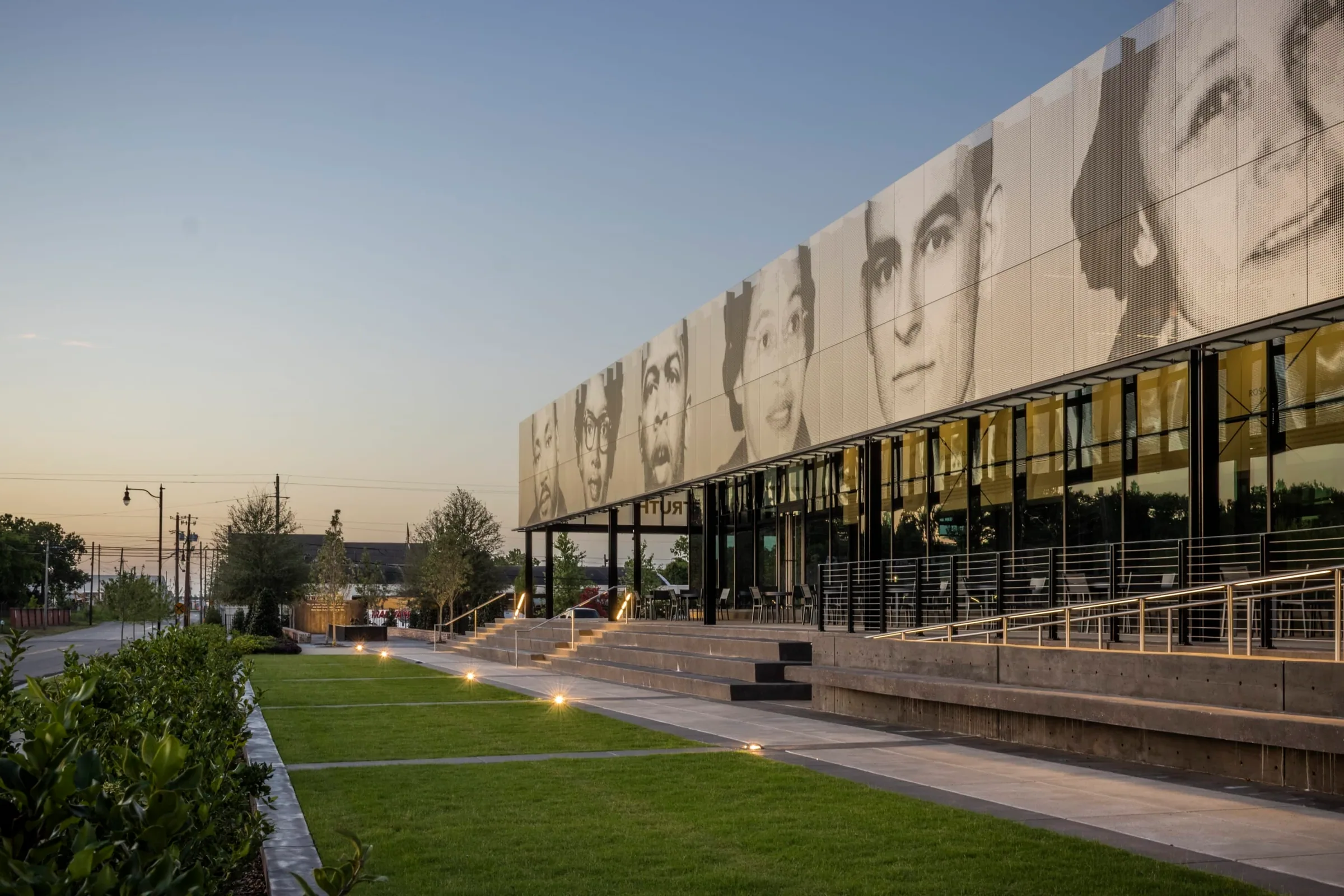 The pavilion from the lawn, the portraits glowing at dusk