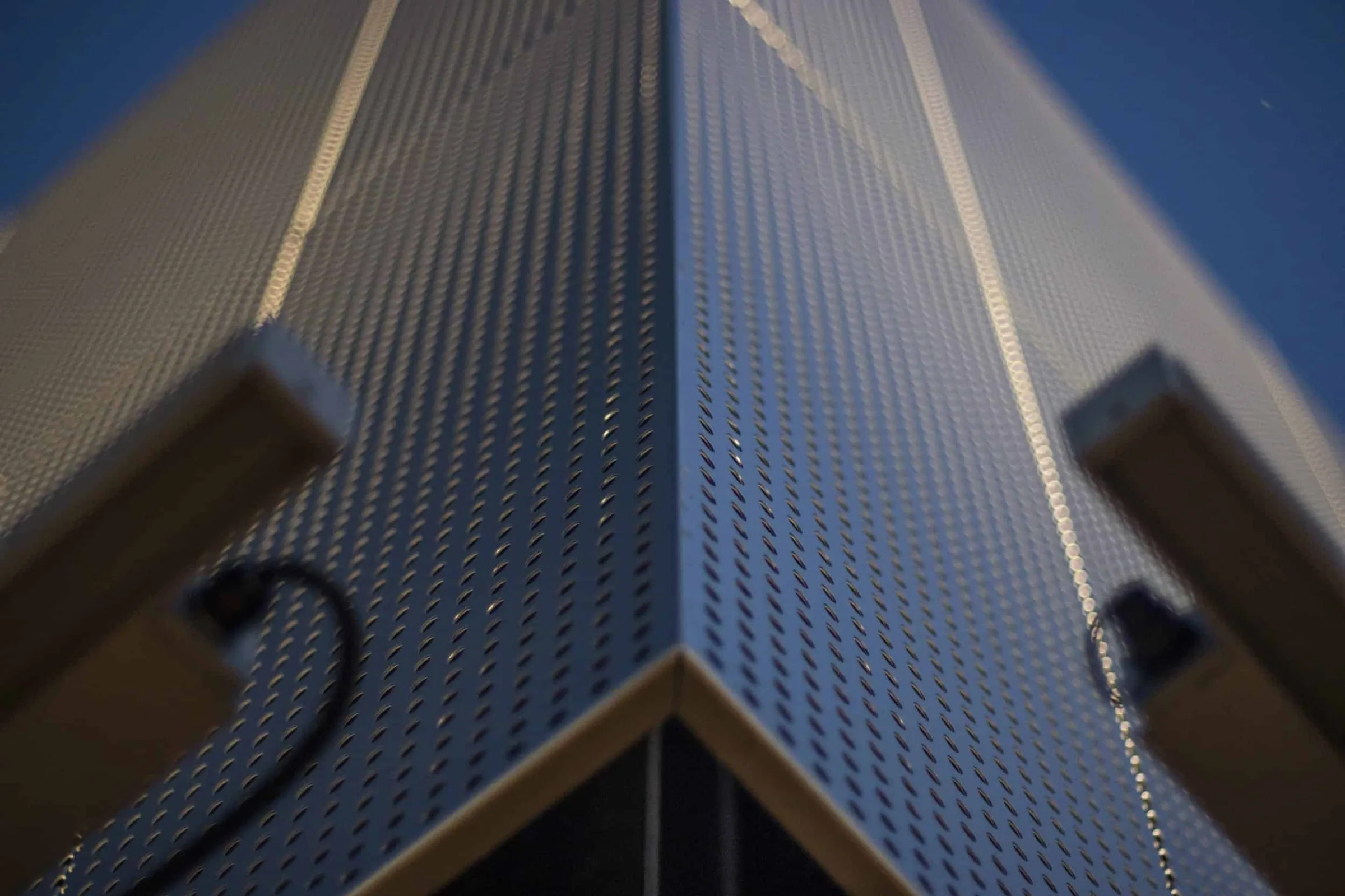 A perforated panel folded around the awning’s corner