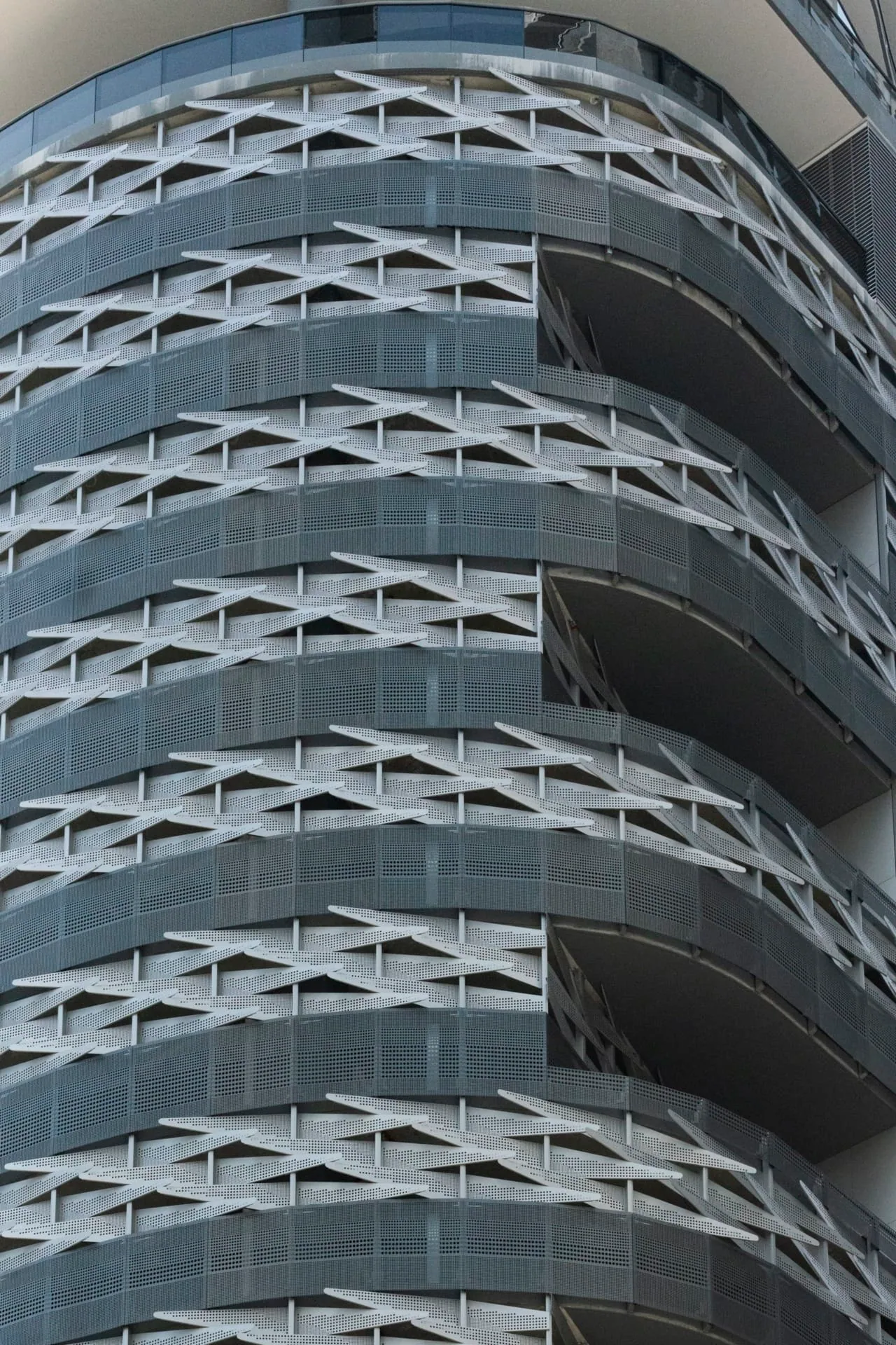 The rounded garage corner, floor after floor of perforated metal