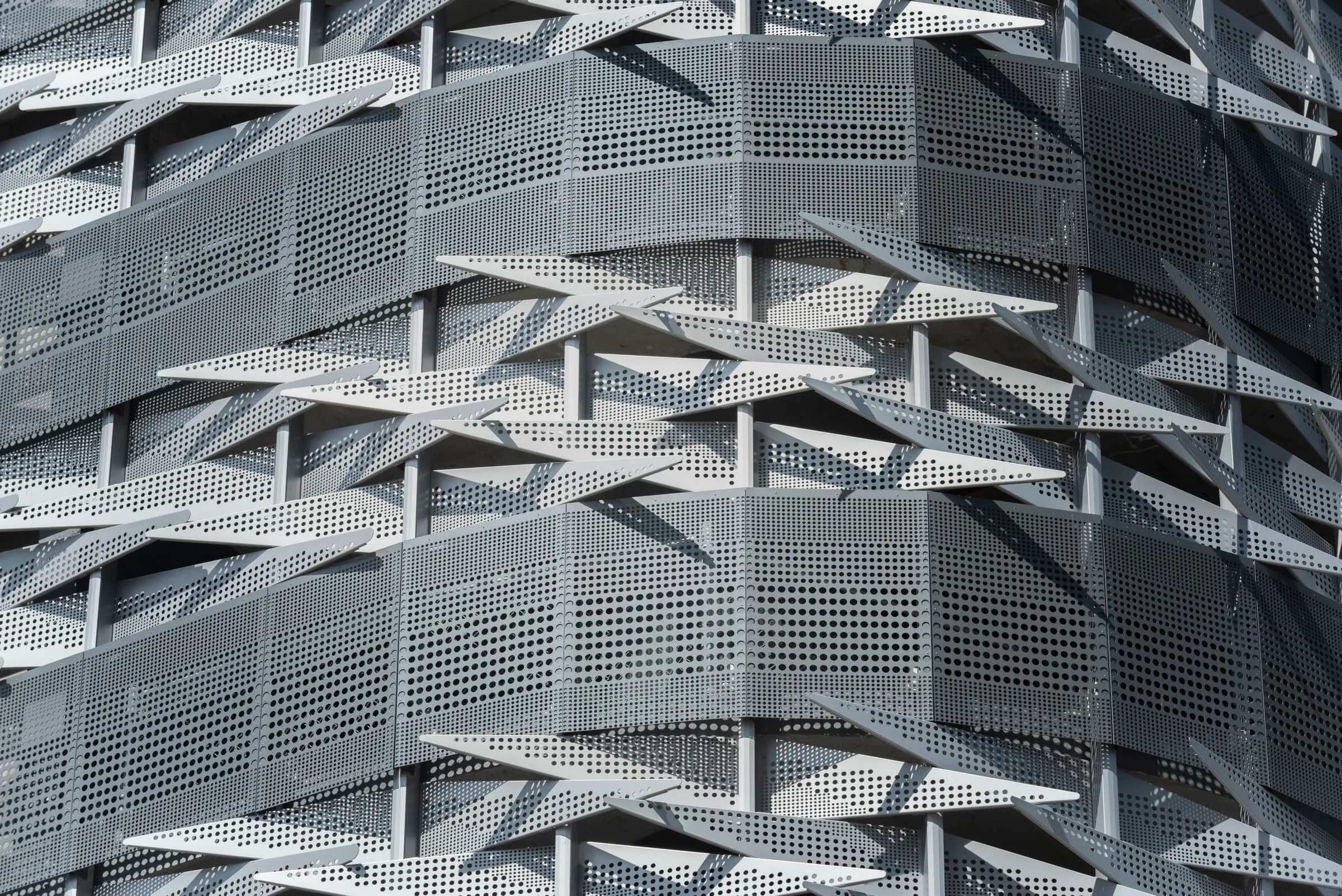Close on the angled perforated fins of the garage façade