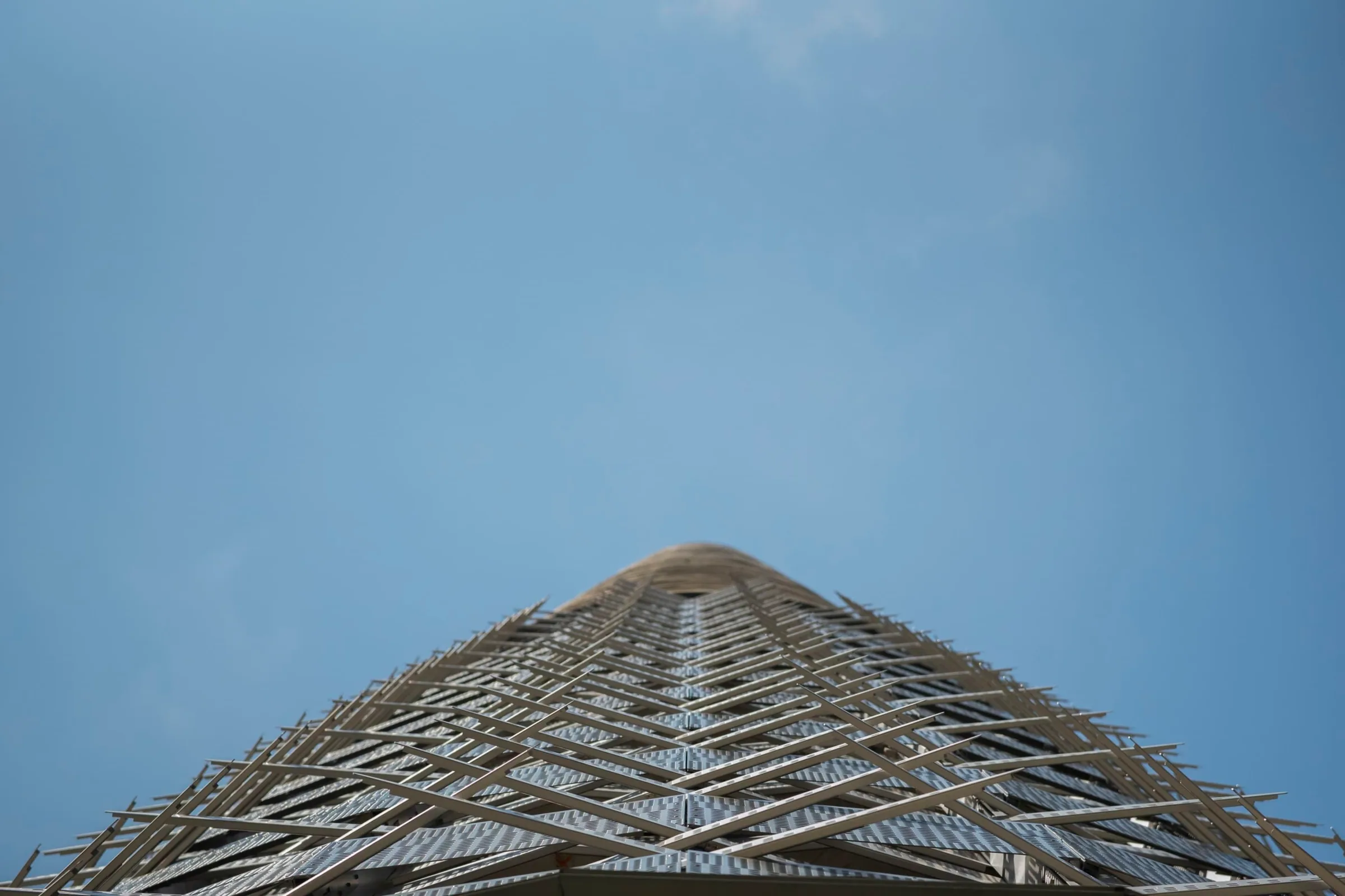 Looking straight up the façade to a blue sky
