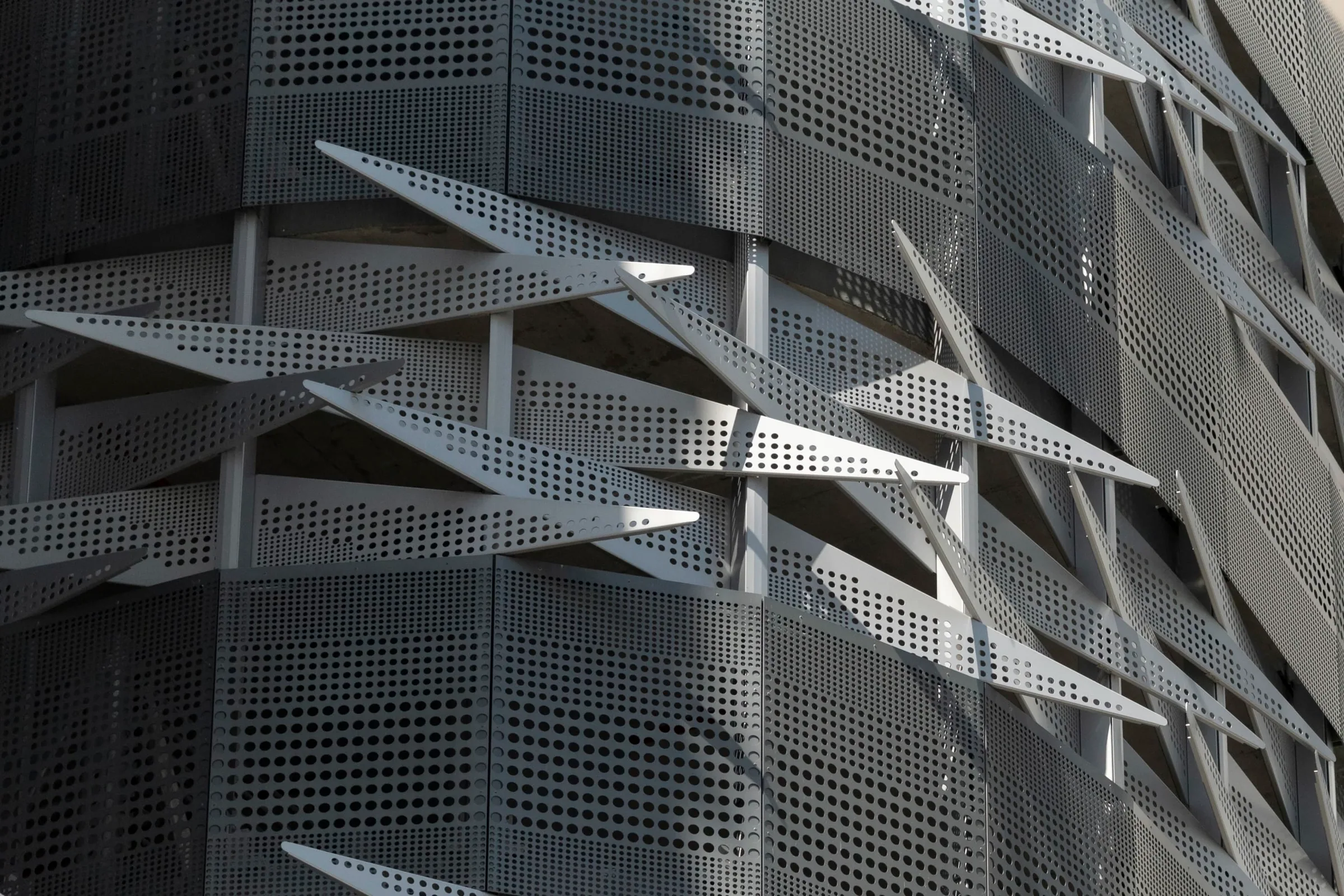 Perforated fins stepping out from the façade