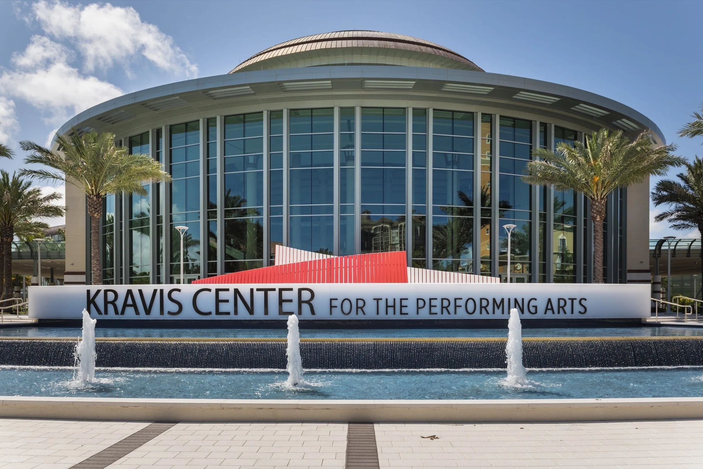 The Kravis Center sign and fountains with the red bench behind