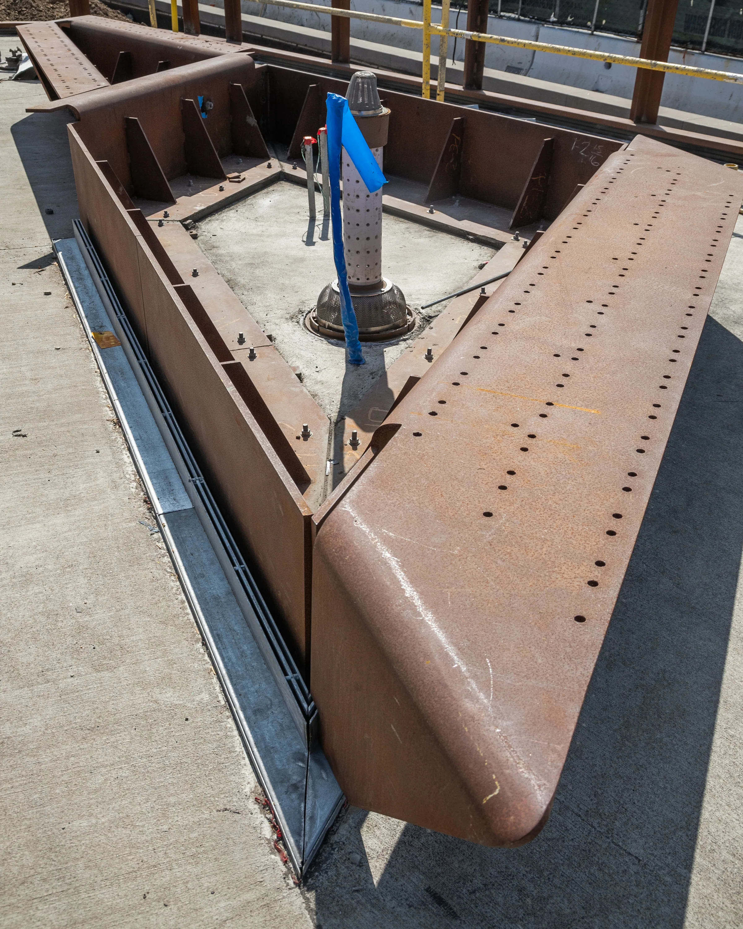 A pointed steel planter edge set into the paving