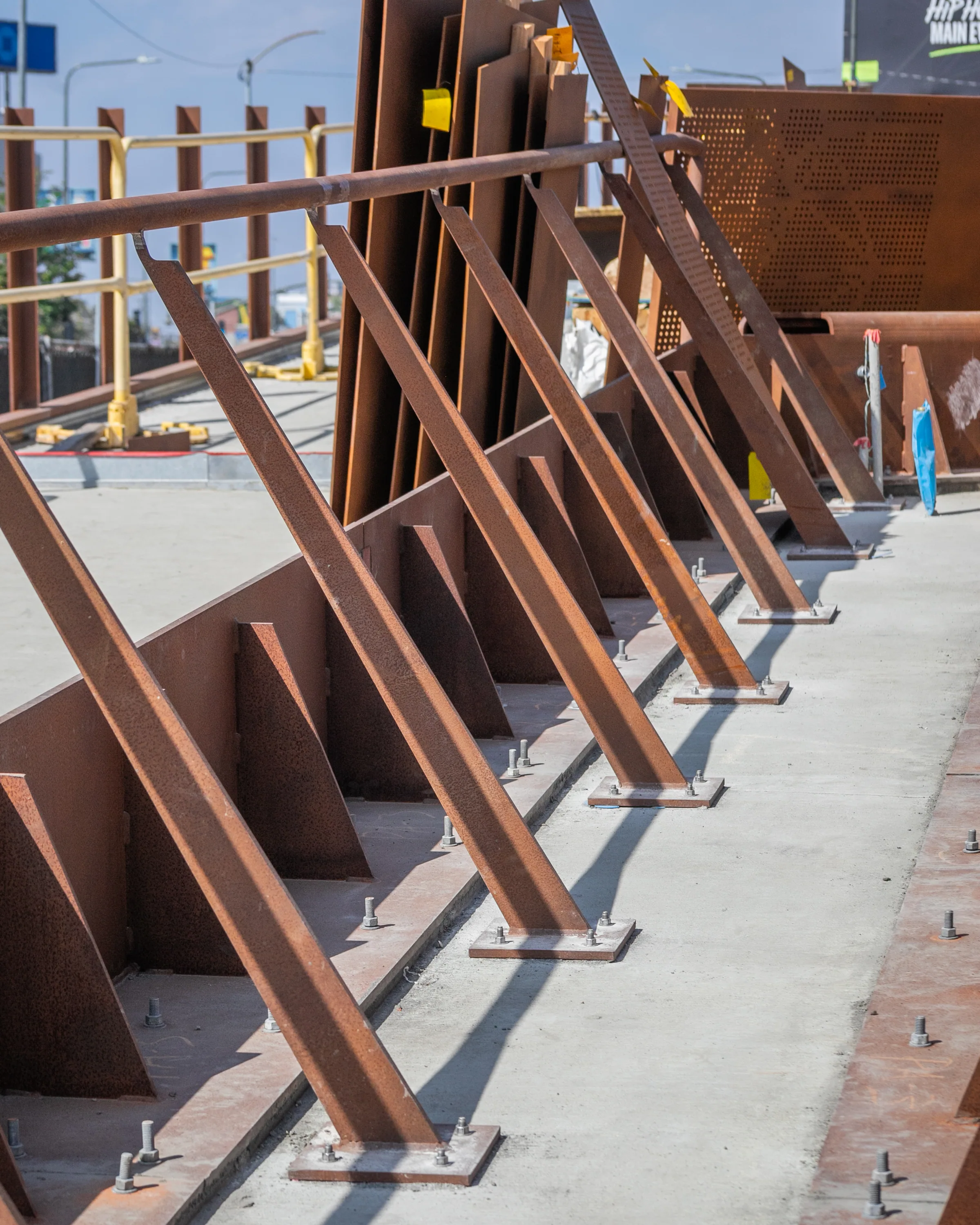 A row of angled steel posts along a ramp