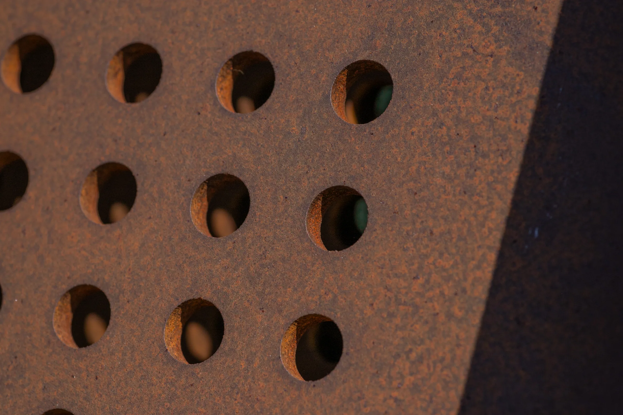 Close on round perforations in weathered steel