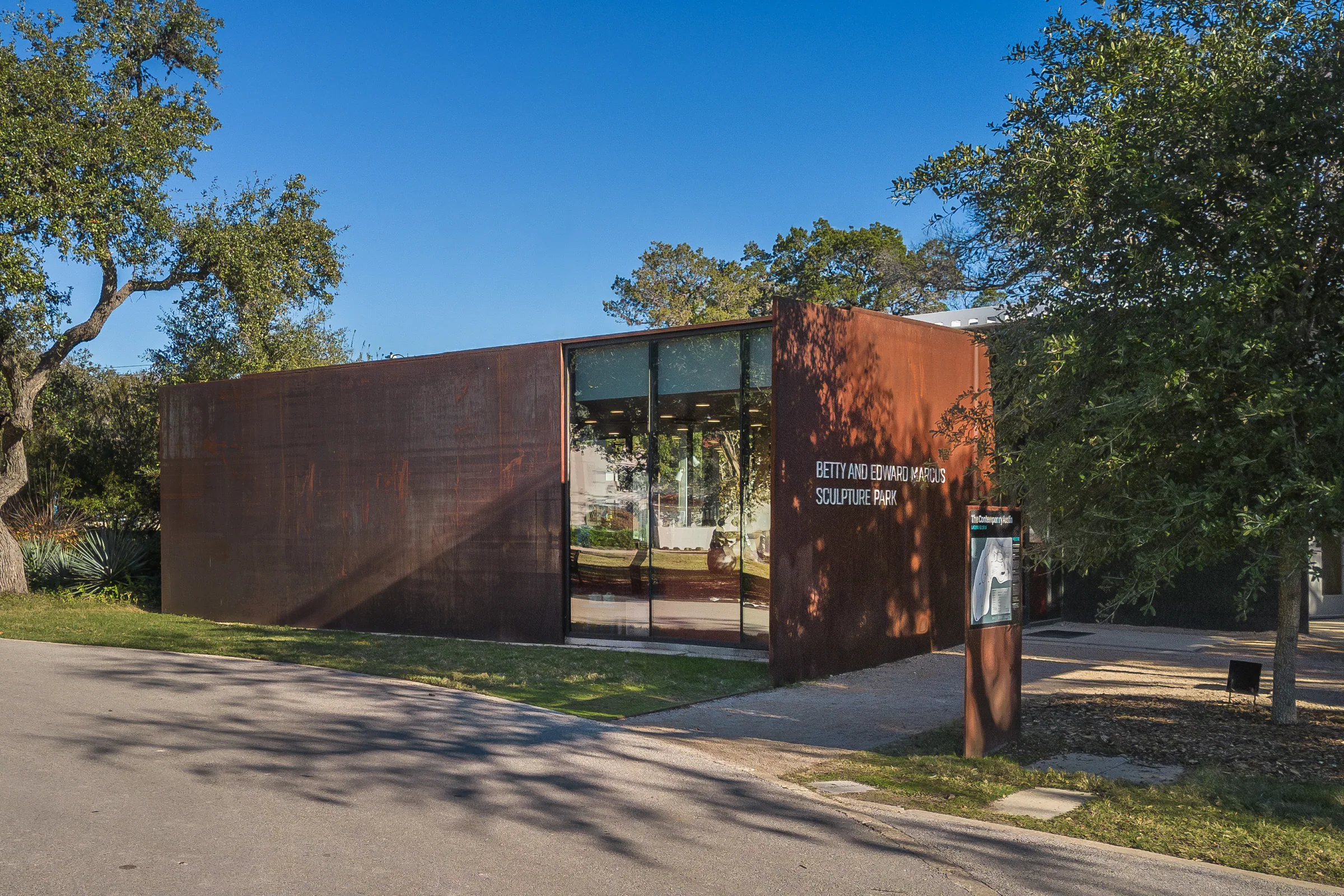 The steel pavilions and entry from the drive