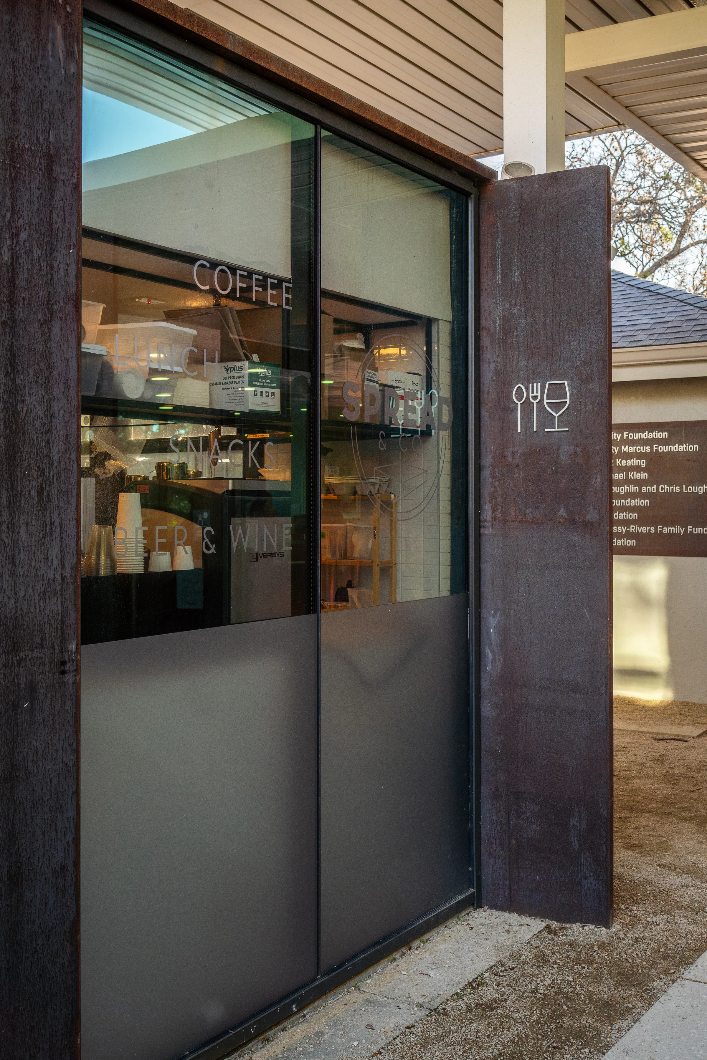 A glass door set between weathering steel walls