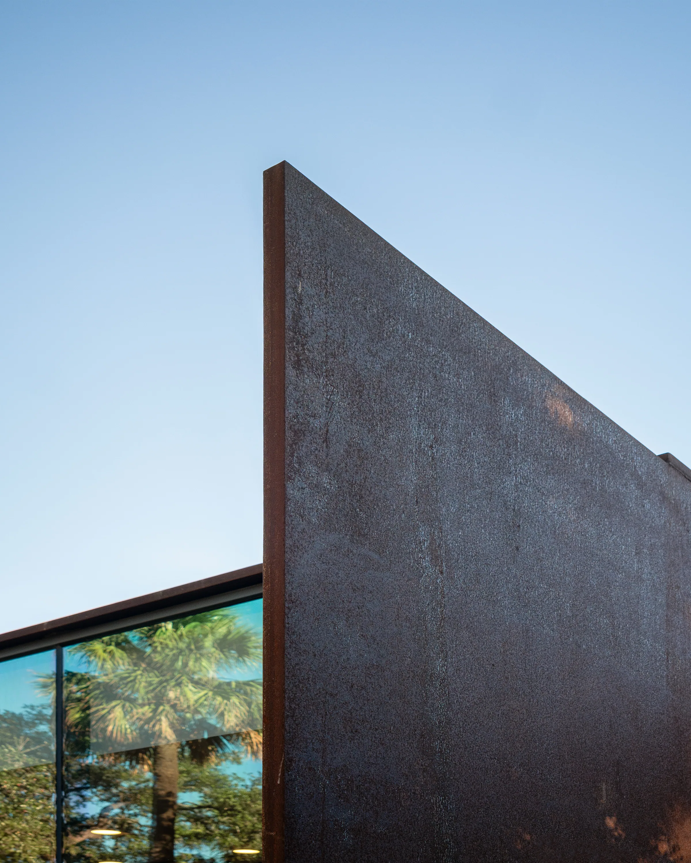 The sharp top edge of a steel plane against blue sky