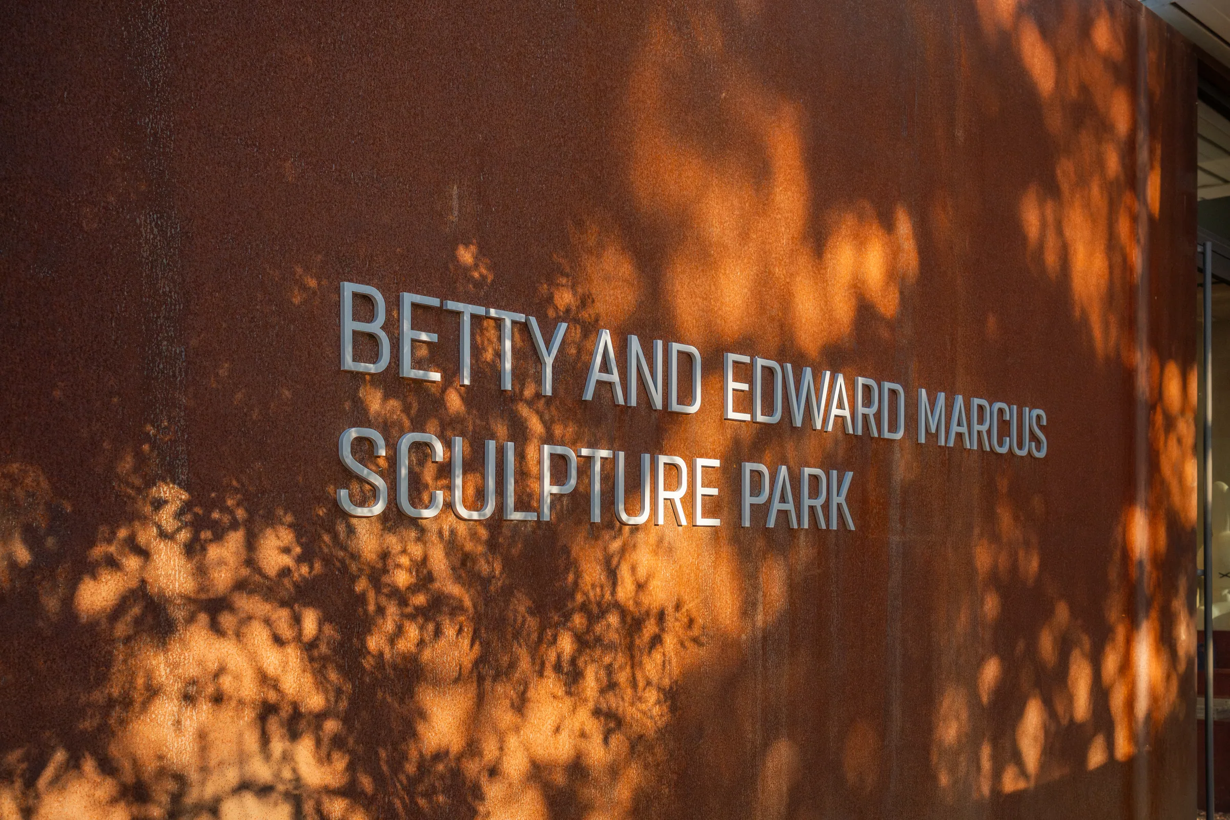 Close on the sculpture park lettering in patterned shade