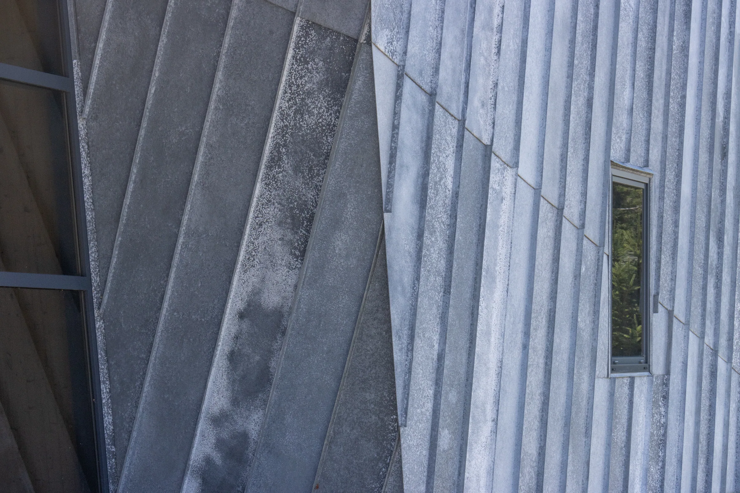 Diagonal zinc panels around a narrow window