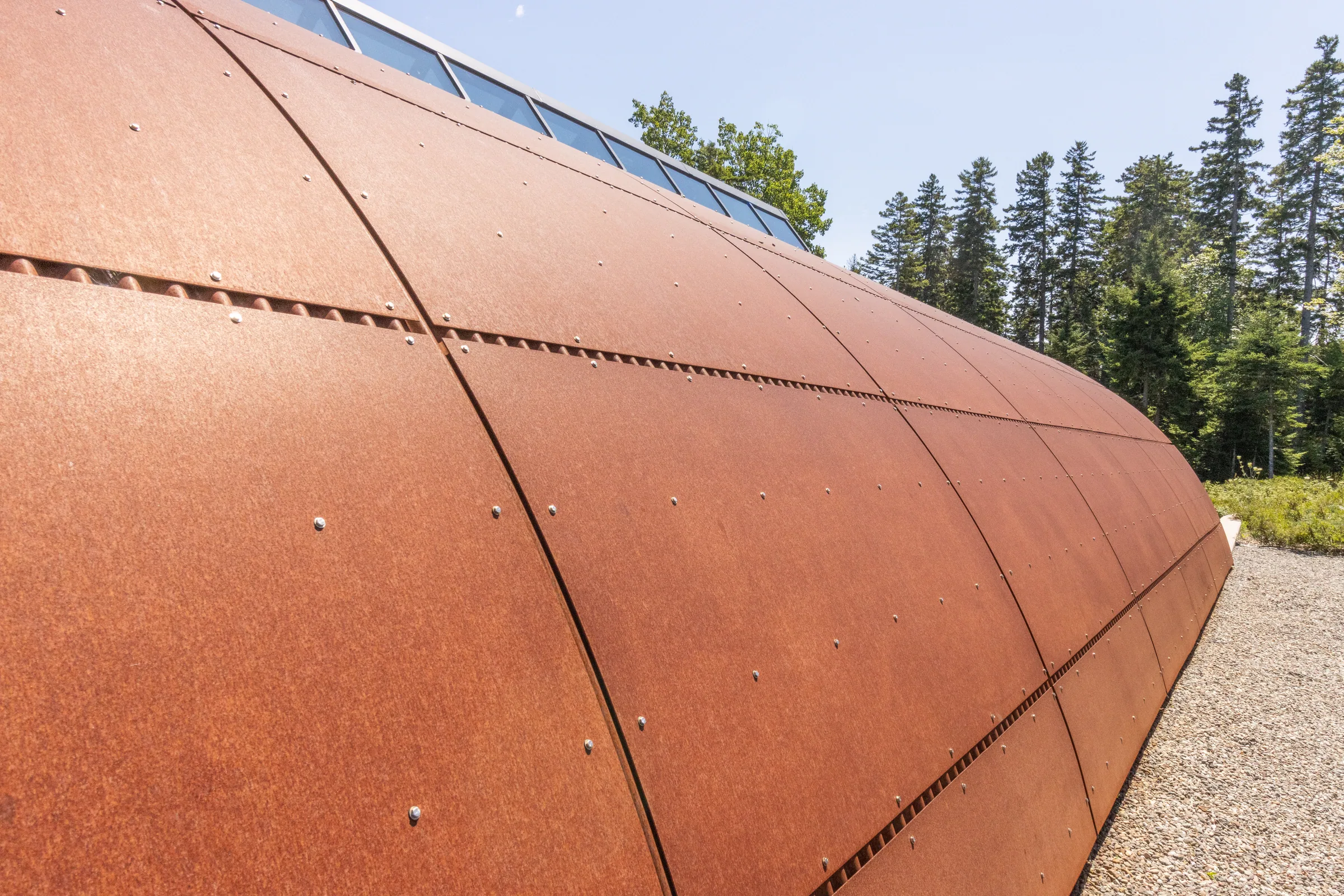 Weathering steel panels with rows of fasteners along the vault