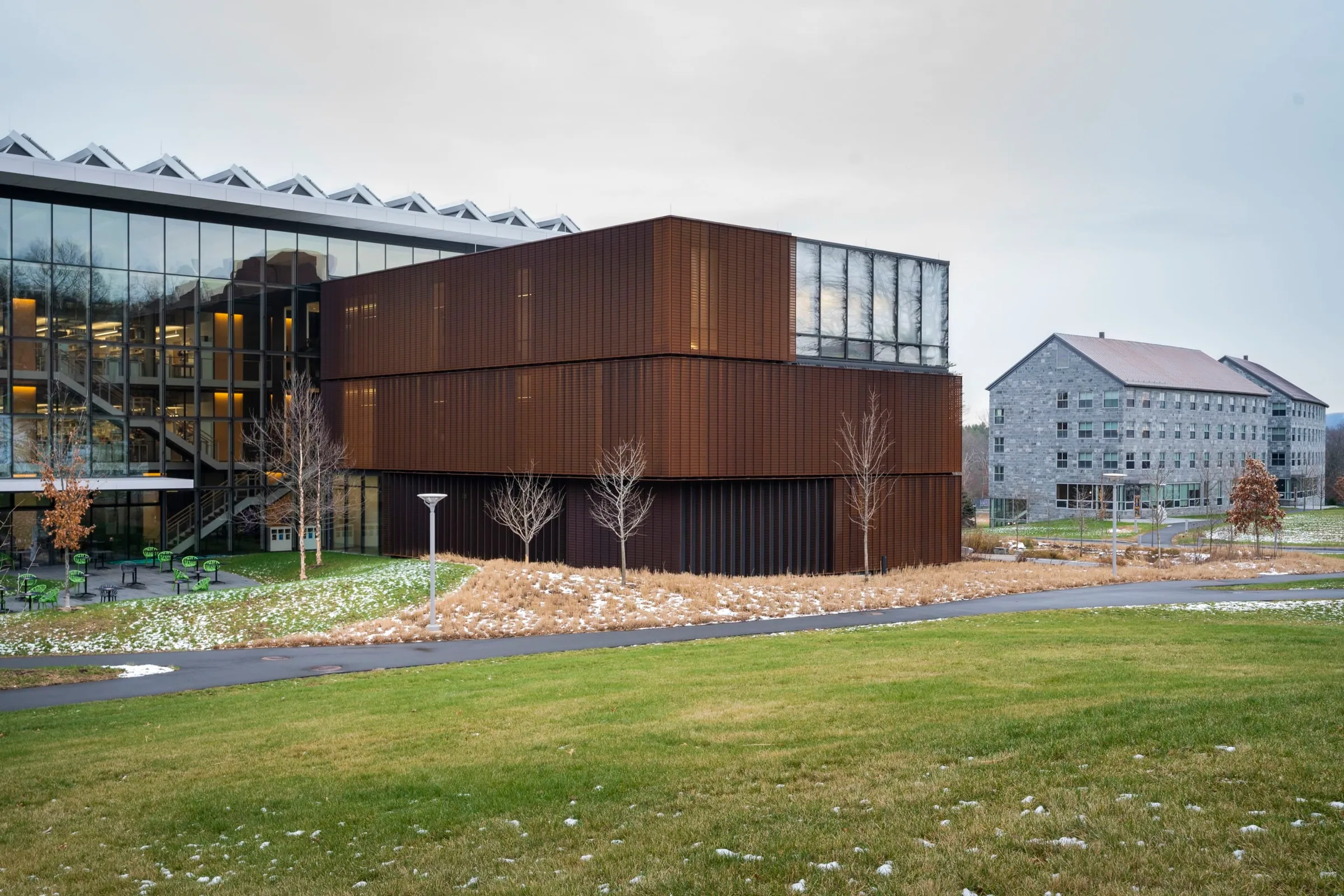 The steel-clad wing and glass atrium across the lawn