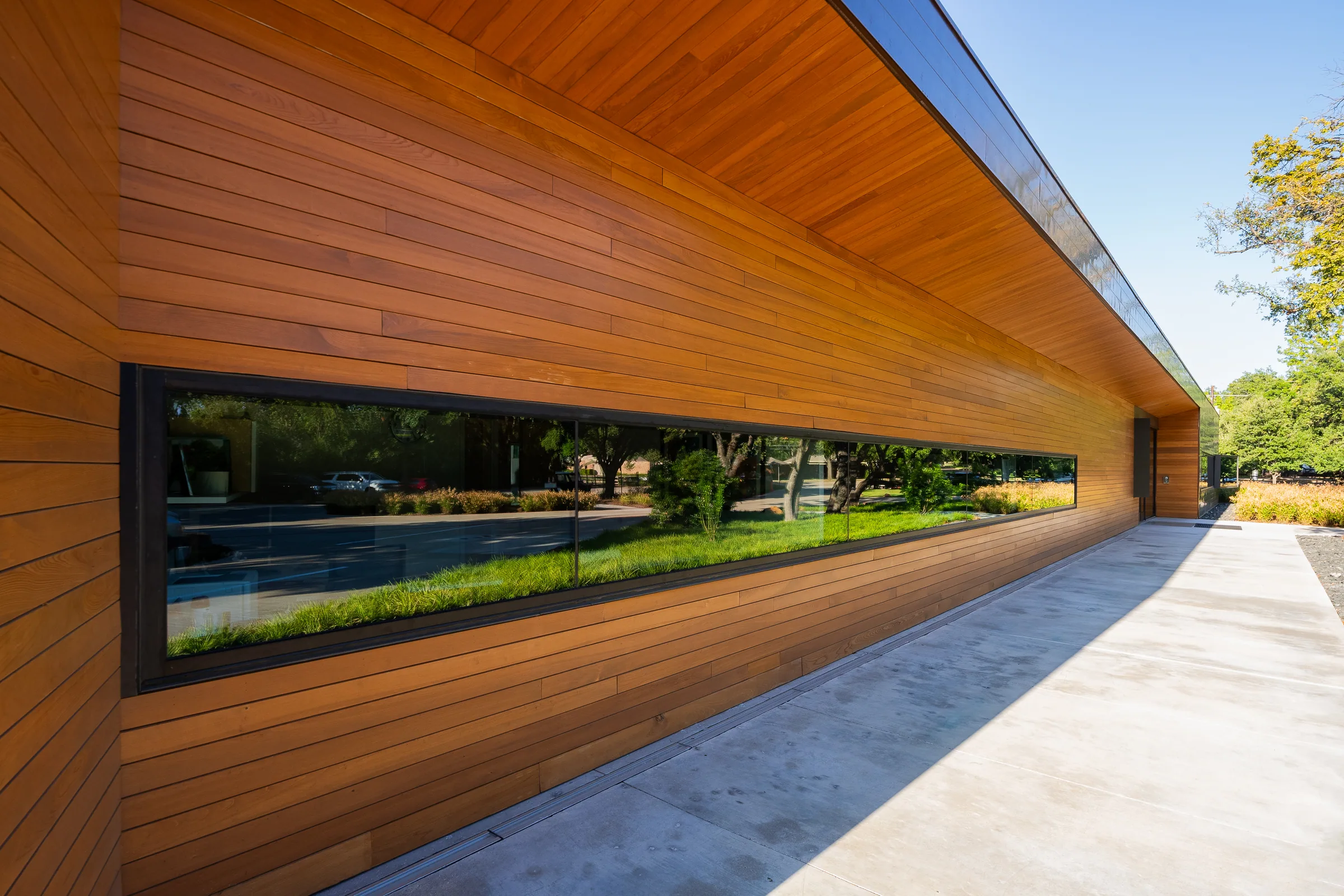 A ribbon window set into wood-lined cladding