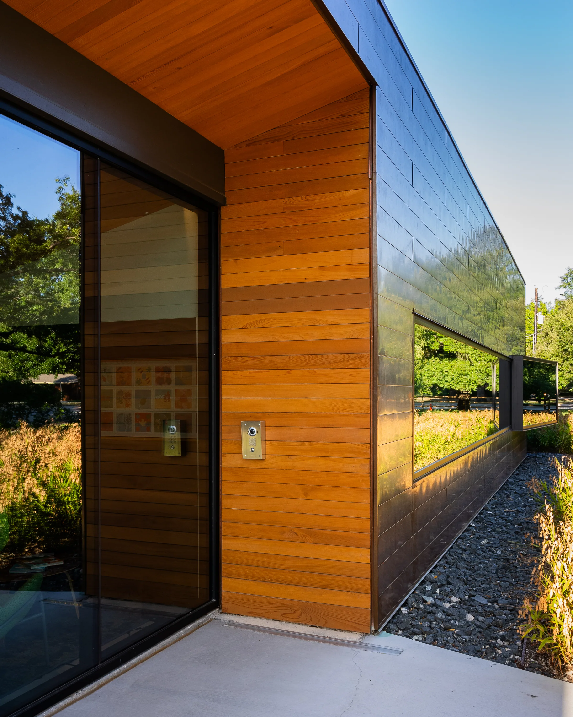 Copper and wood meeting at a tall glass door