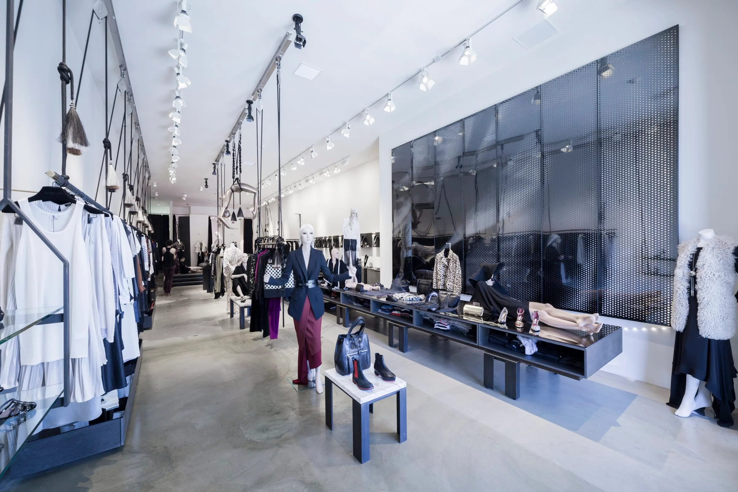 The long white boutique with its black steel wall at the back
