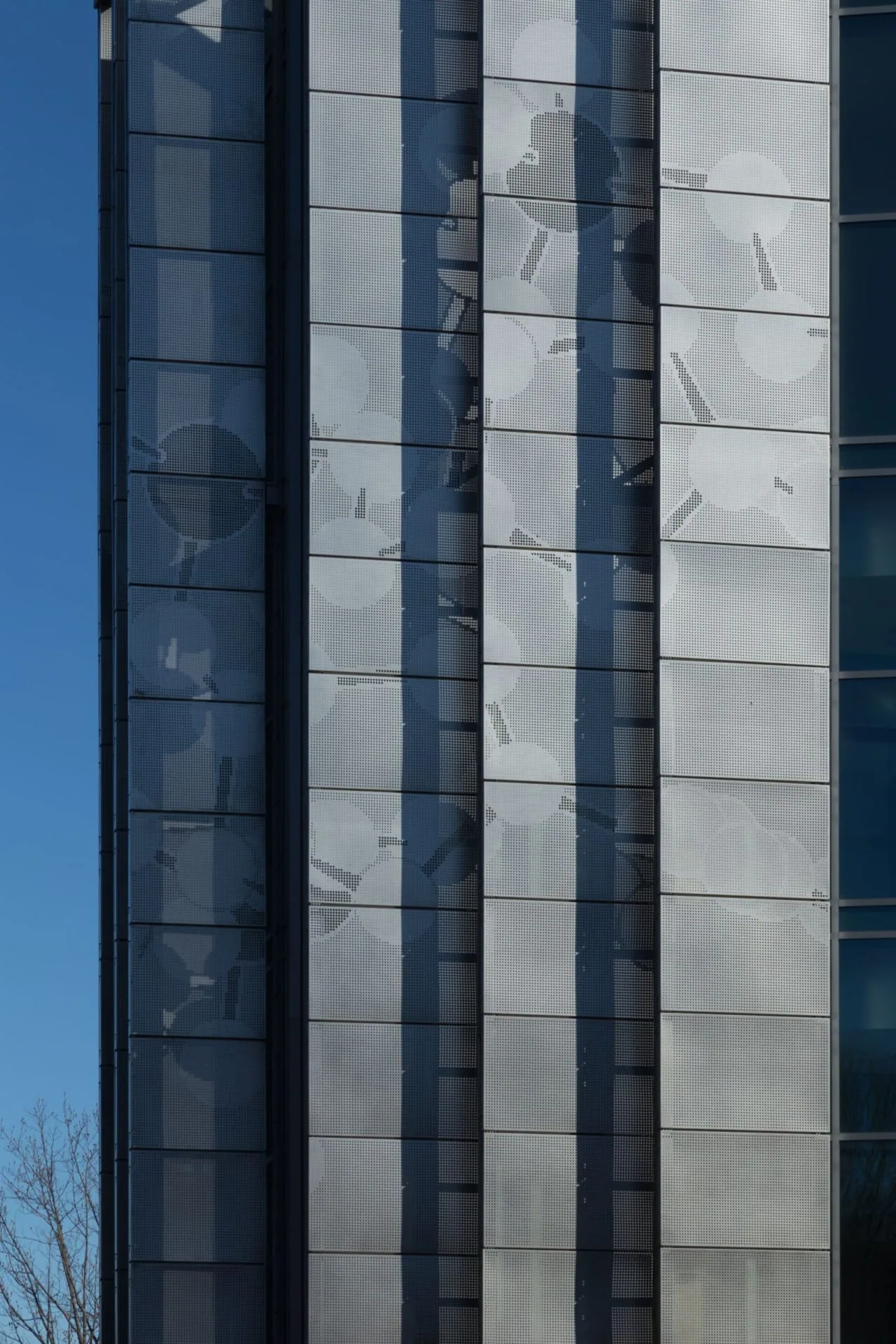 Vertical bands of perforated steel and glass